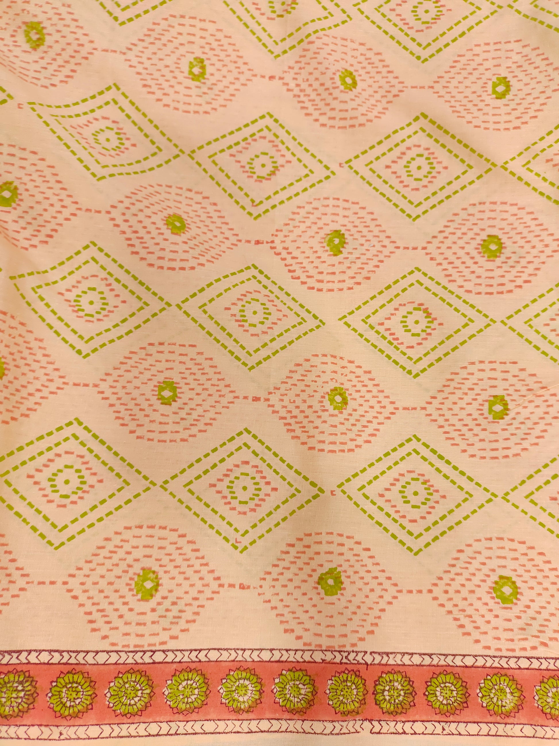 Light Peach hand block fabric print with green & pink with a subtle border