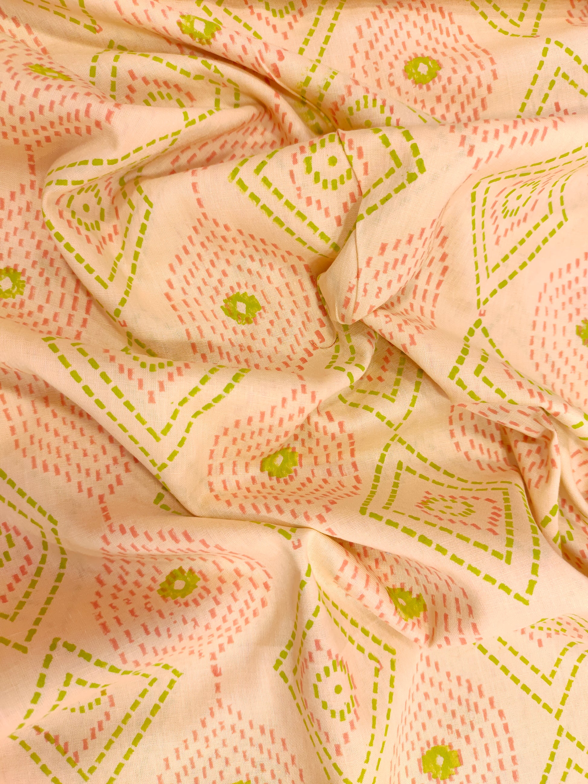 Light Peach hand block fabric print with green & pink with a subtle border