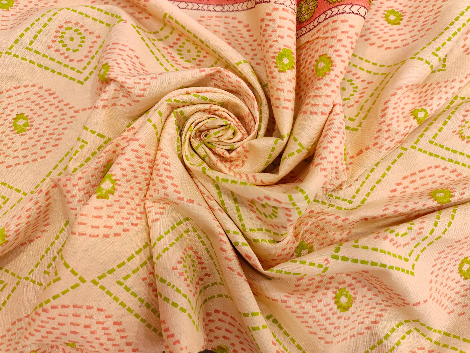 Light Peach hand block fabric print with green & pink with a subtle border