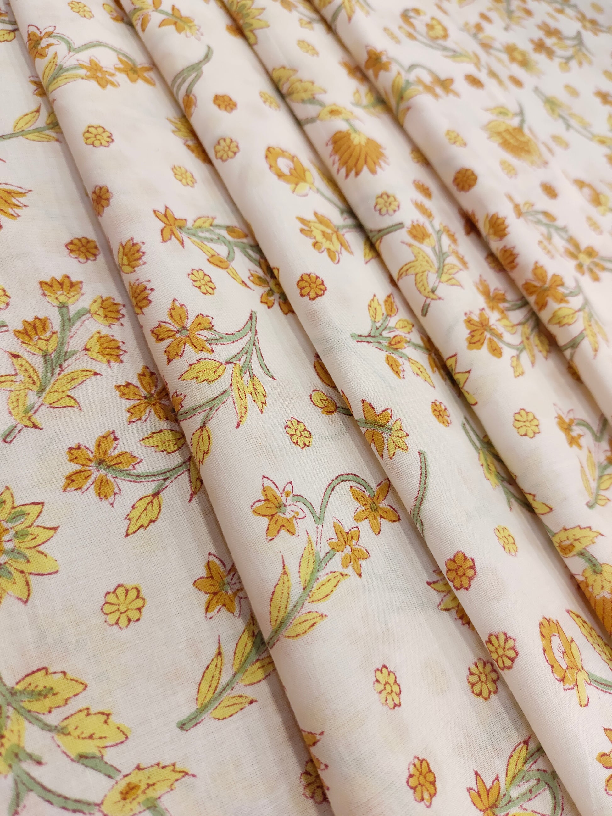 Yellow with mustard flowers on a white base cotton handblock print