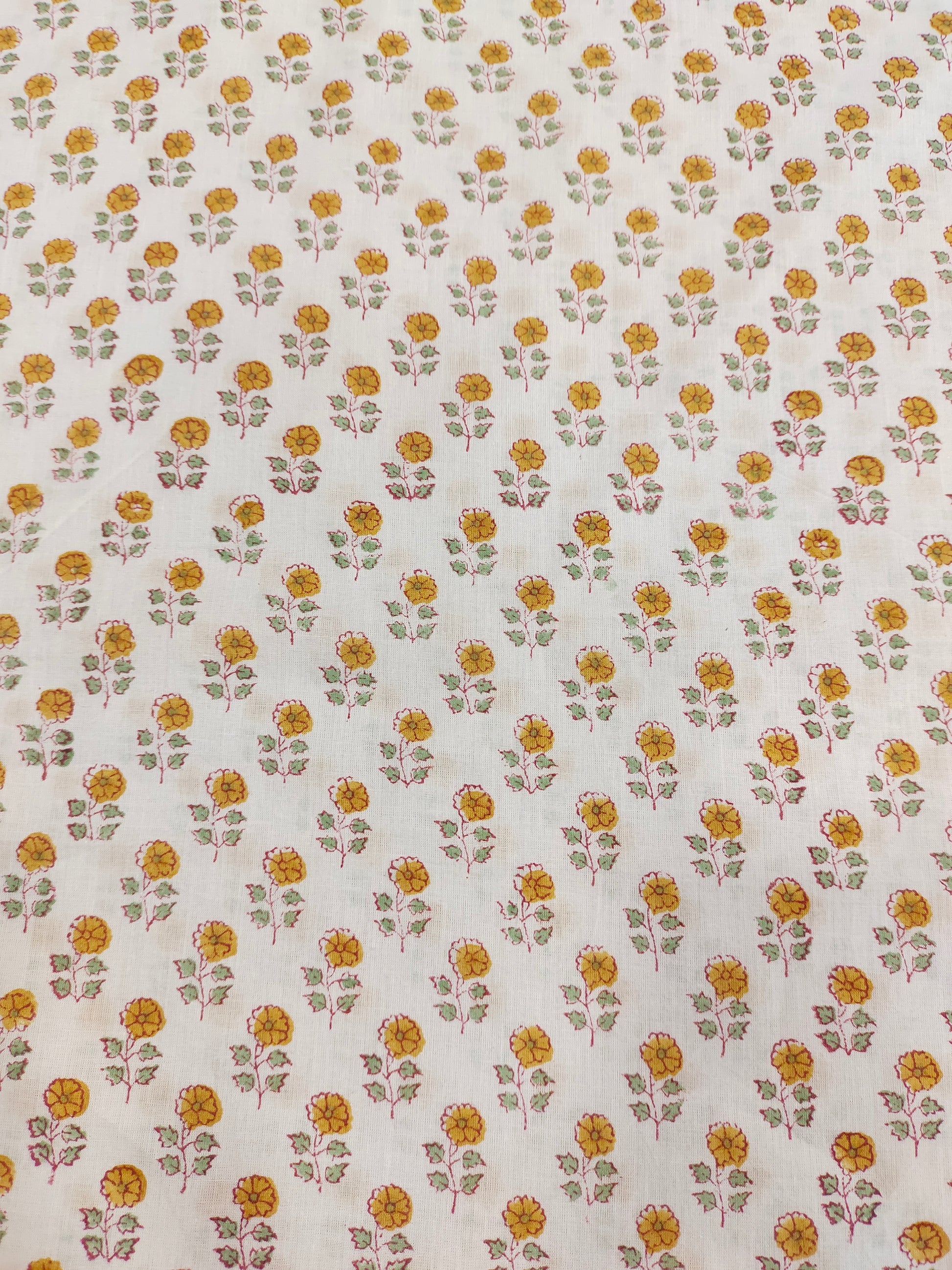 White cotton fabric with mustard and green handblock print