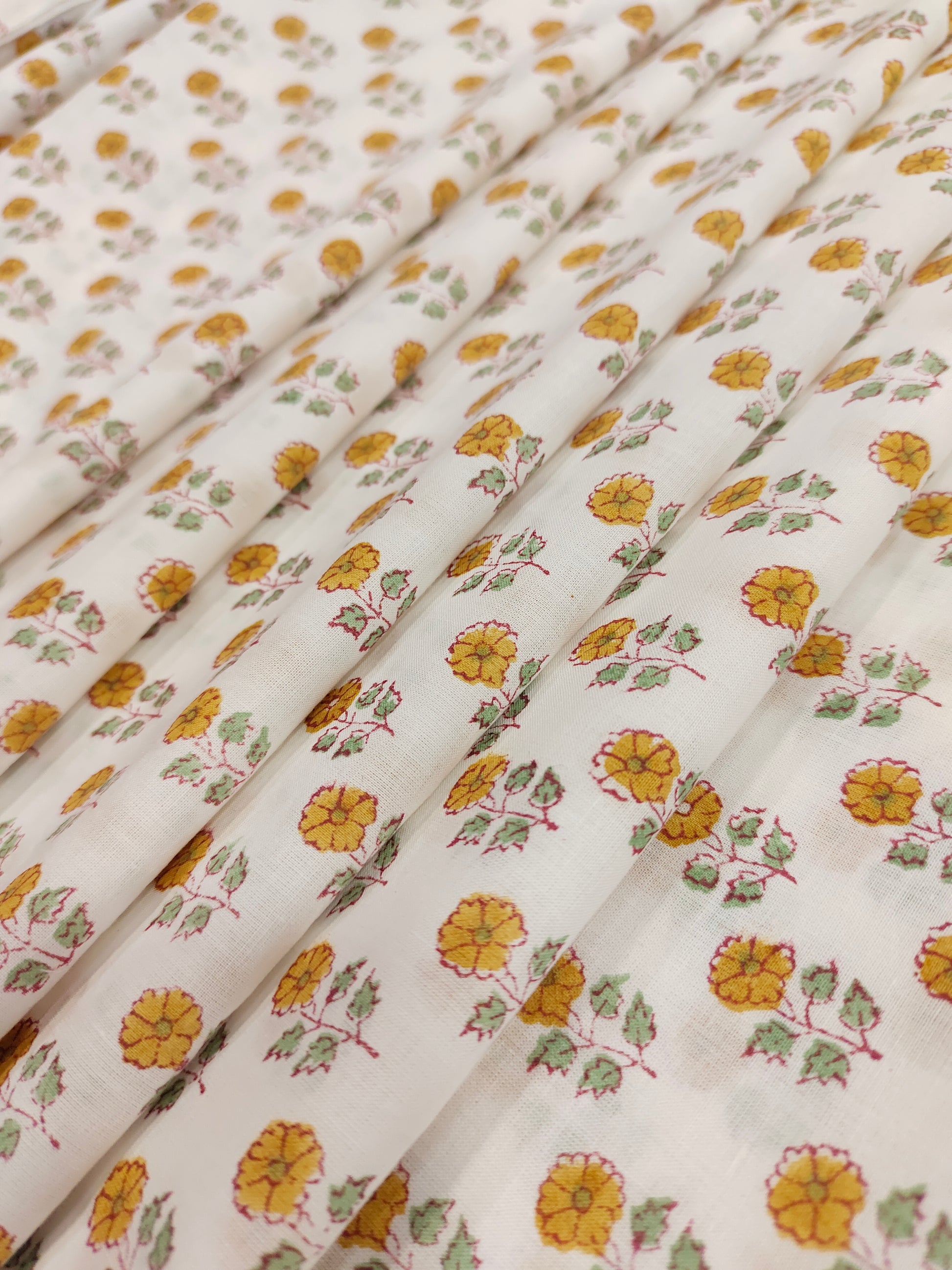 White cotton fabric with mustard and green handblock print