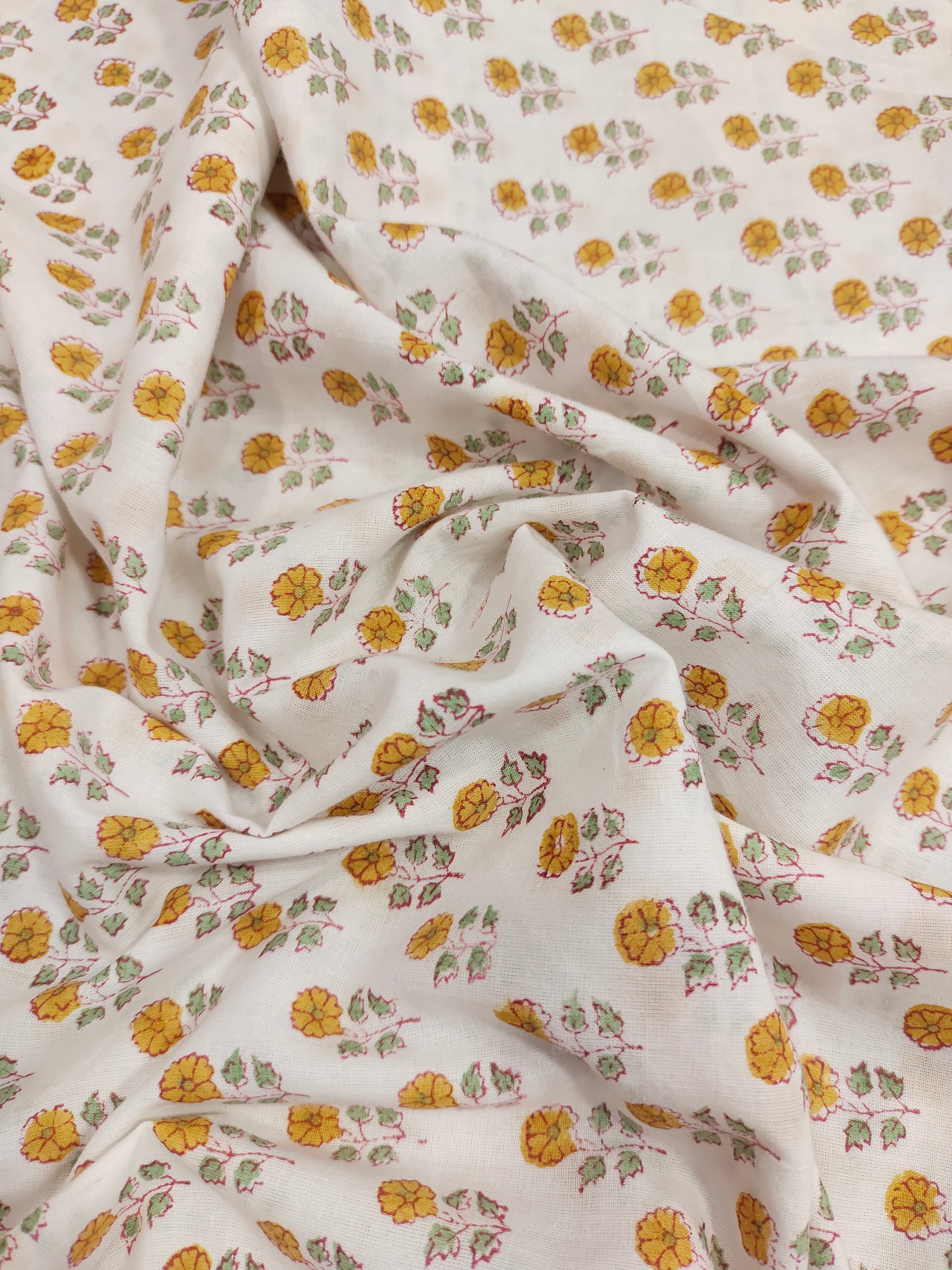 White cotton fabric with mustard and green handblock print