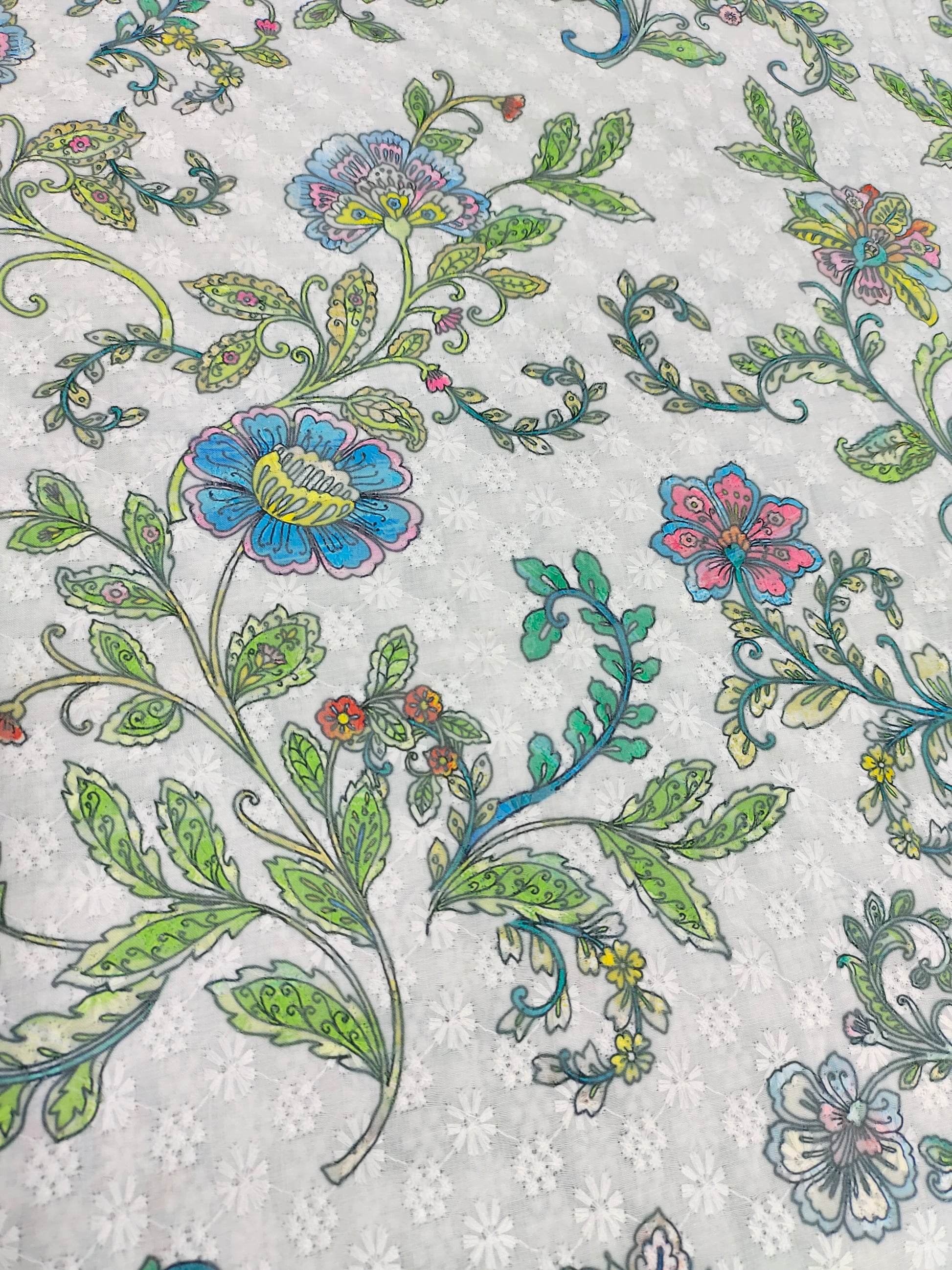 White embroidered fabric digital print with blue pink and green