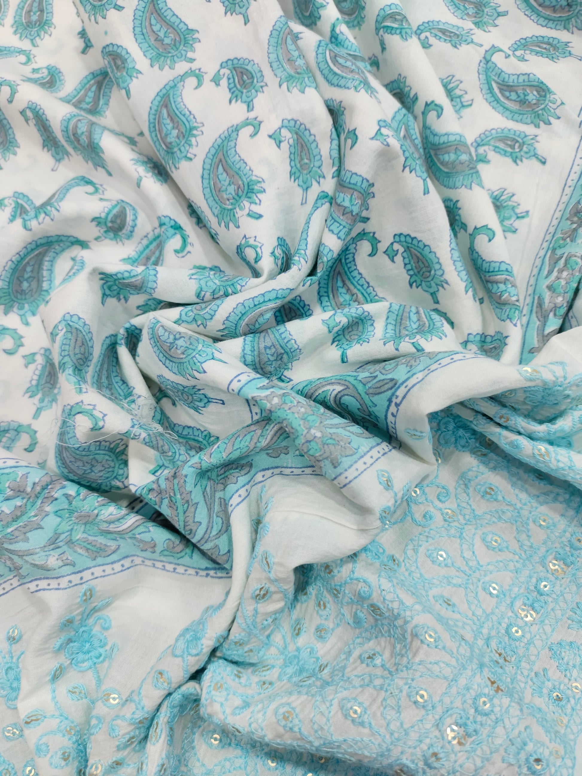 White fabric with blue handblock print and added with schiffli daman