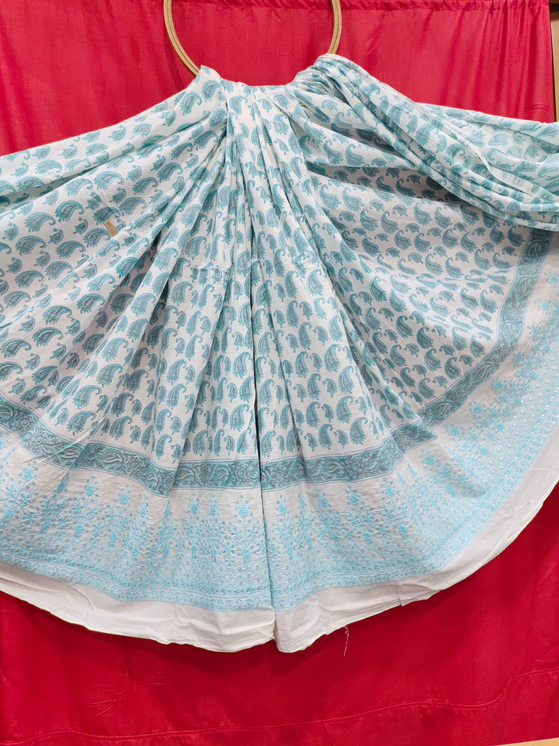 White fabric with blue handblock print and added with schiffli daman