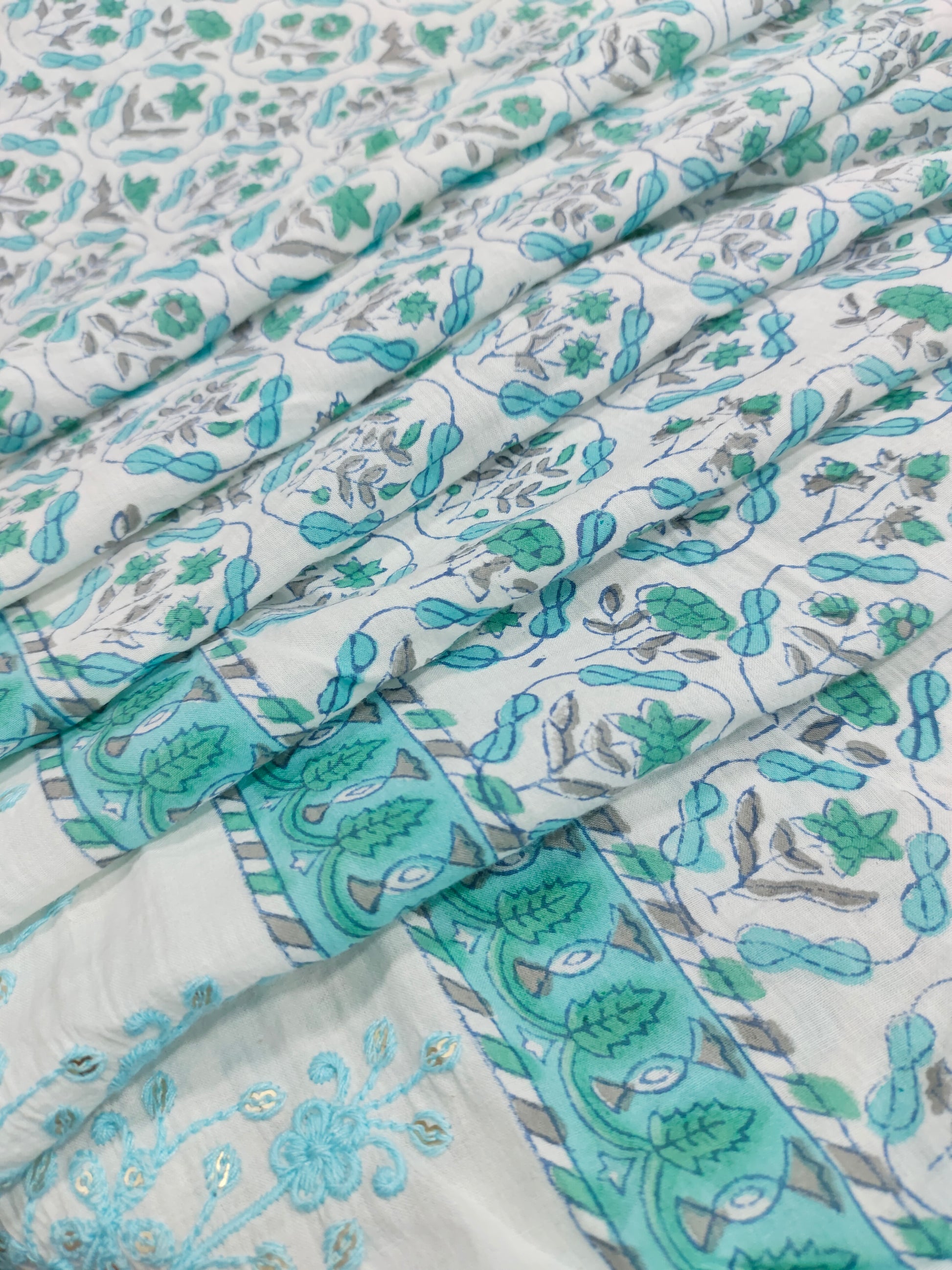 White fabric with blue handblock print and added with schiffli daman