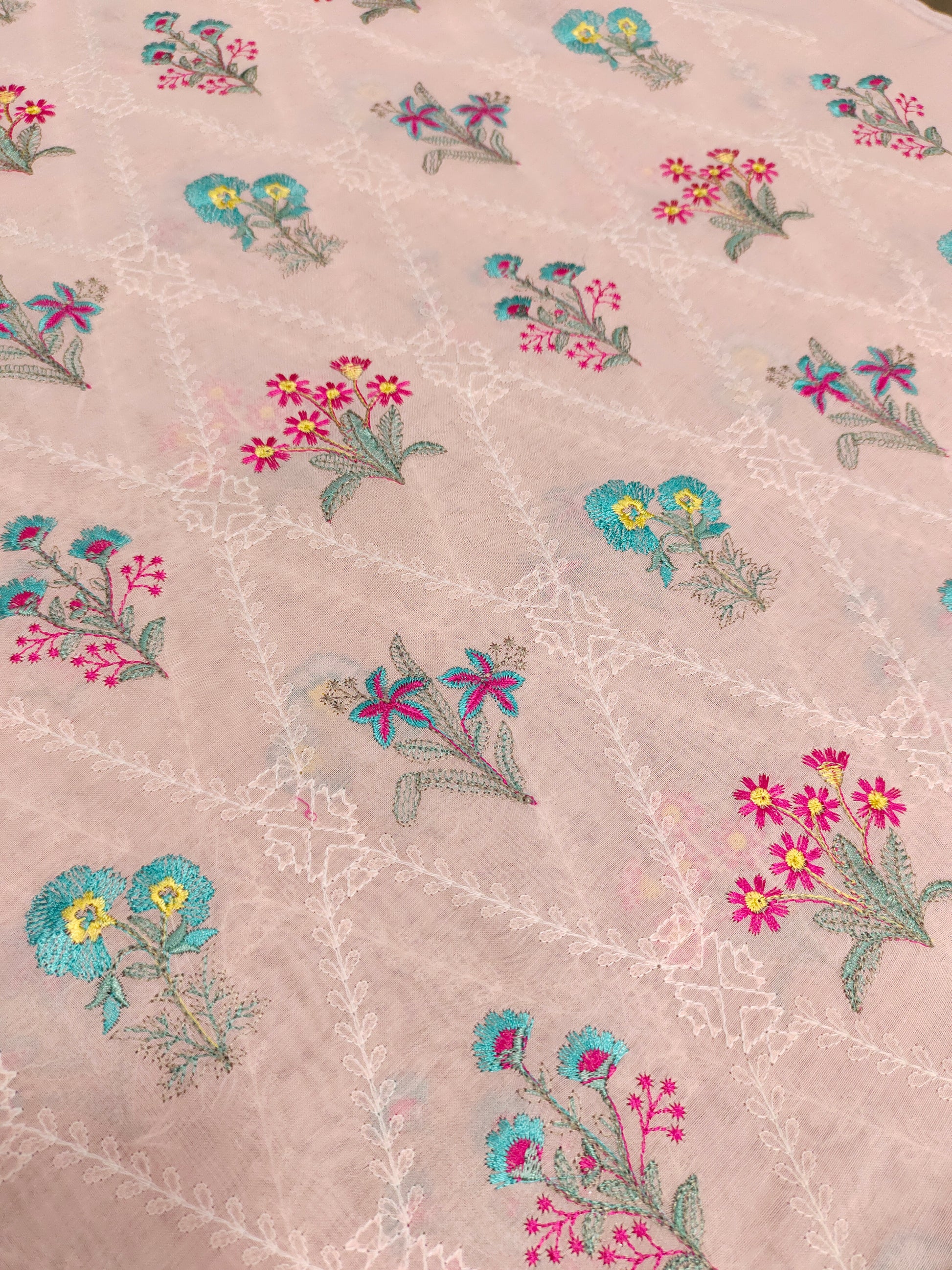 light peach floral embroidery  with blue and pink on voile fabric