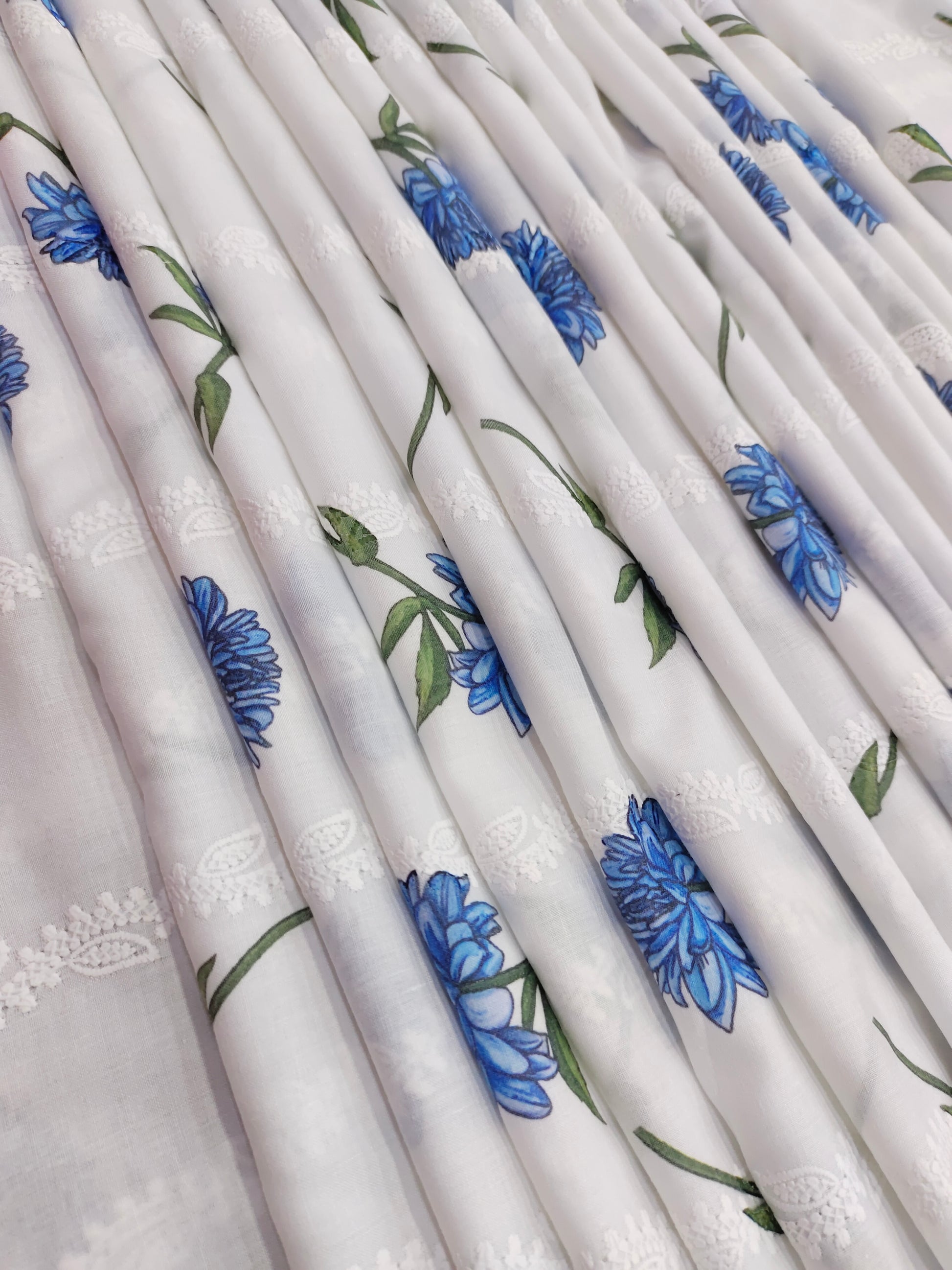 White embroidered with blue flowers
