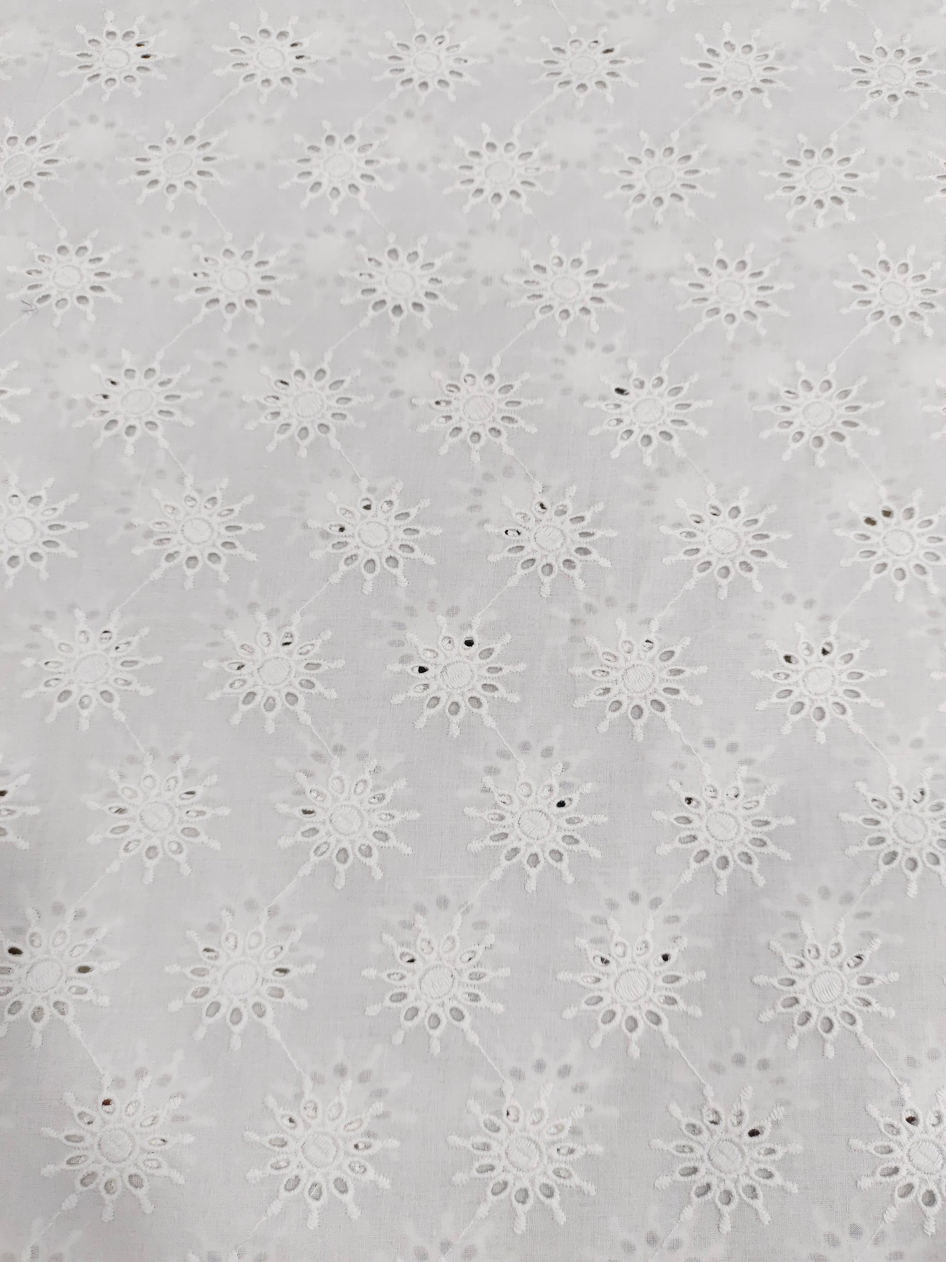 White embroidered cutwork fabric