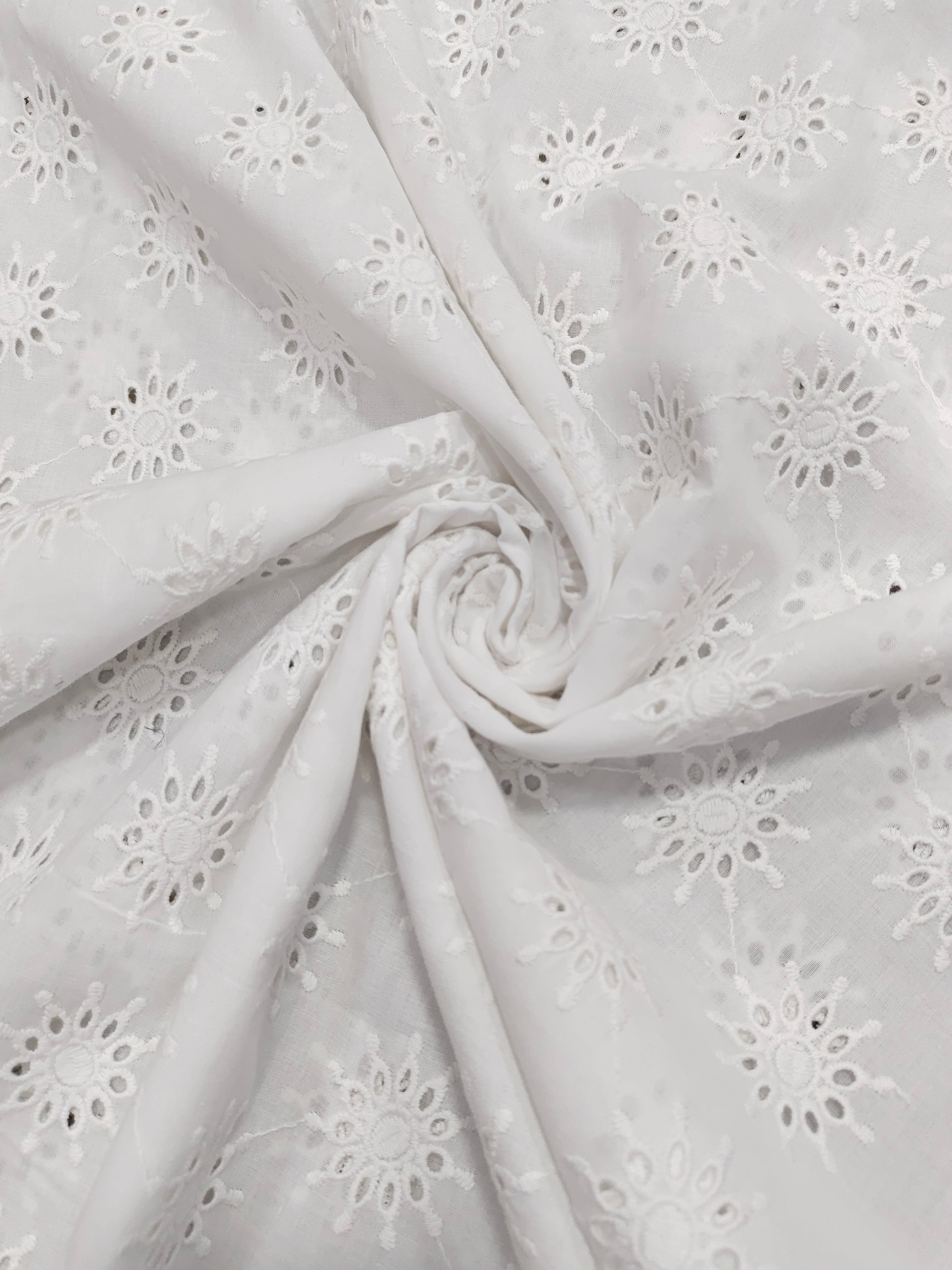 White embroidered cutwork fabric