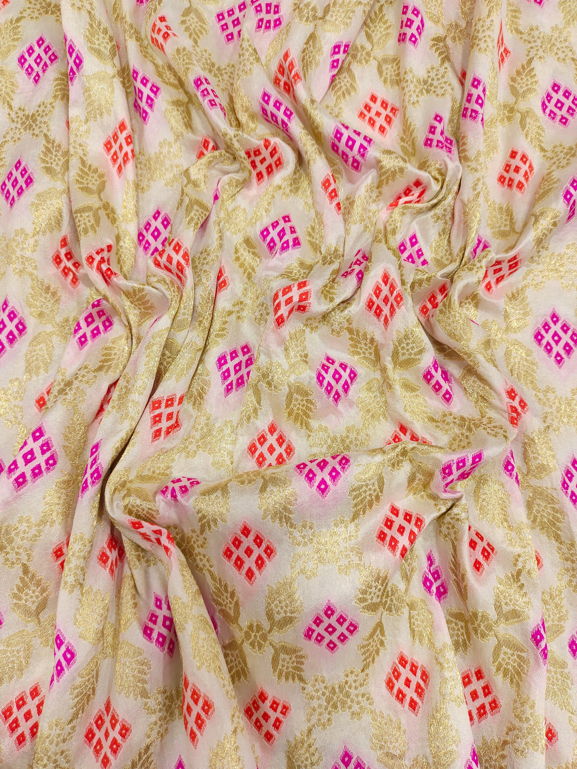 Banarasi silk fabric weave of pink and orange outline gold