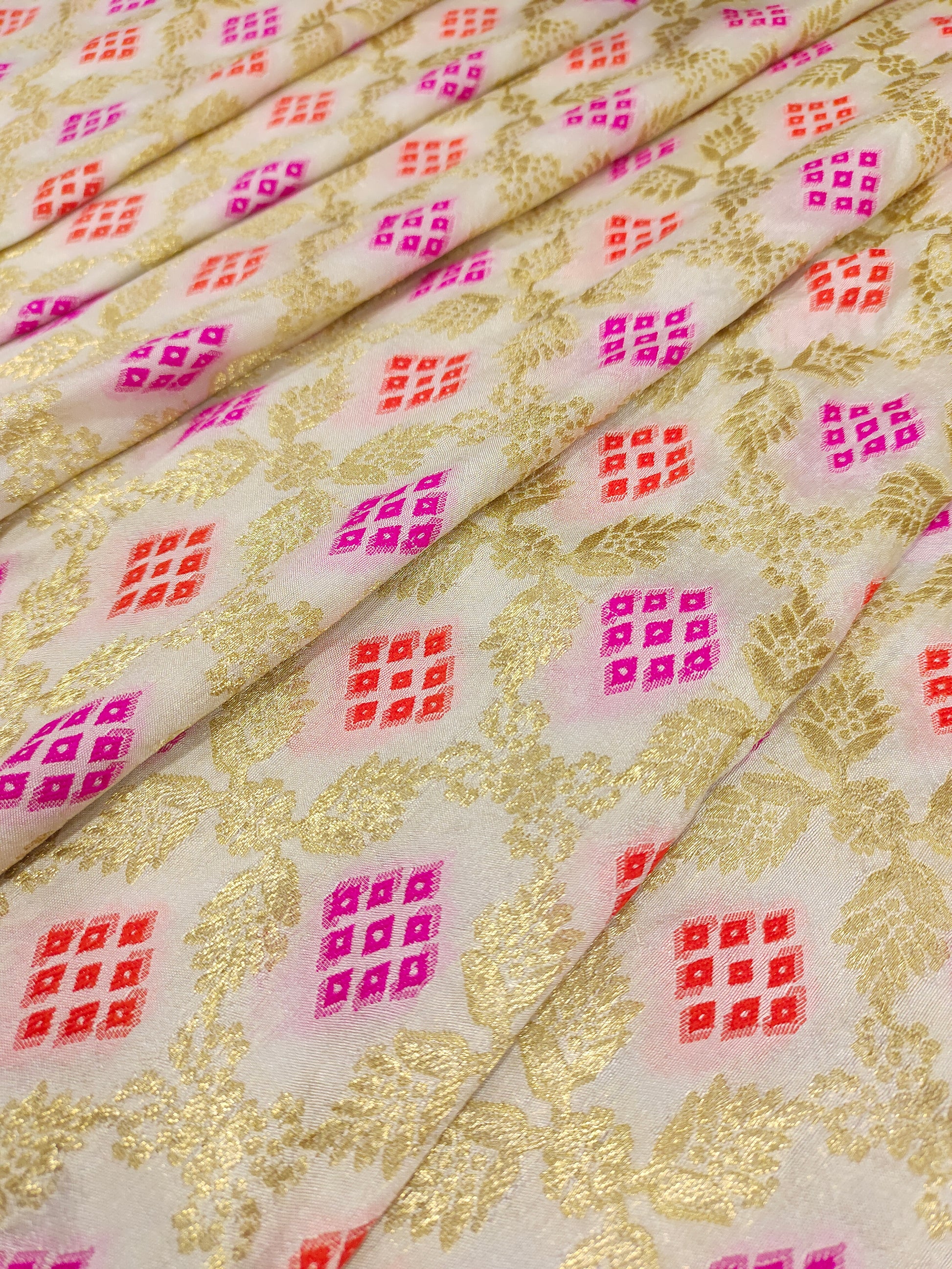 Banarasi silk fabric weave of pink and orange outline gold