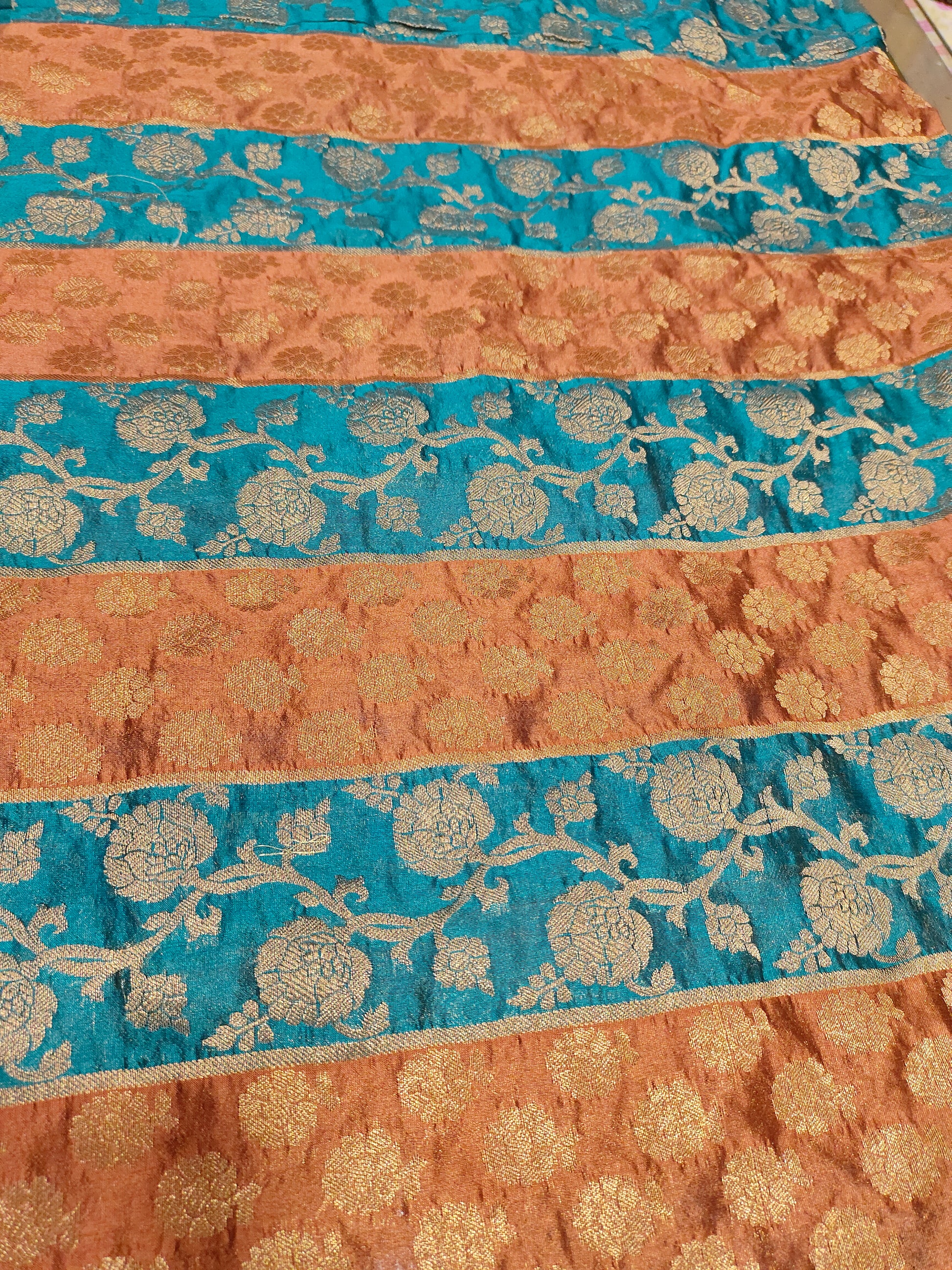 Banarasi stripe fabric with peacock blue and brown with rust weave