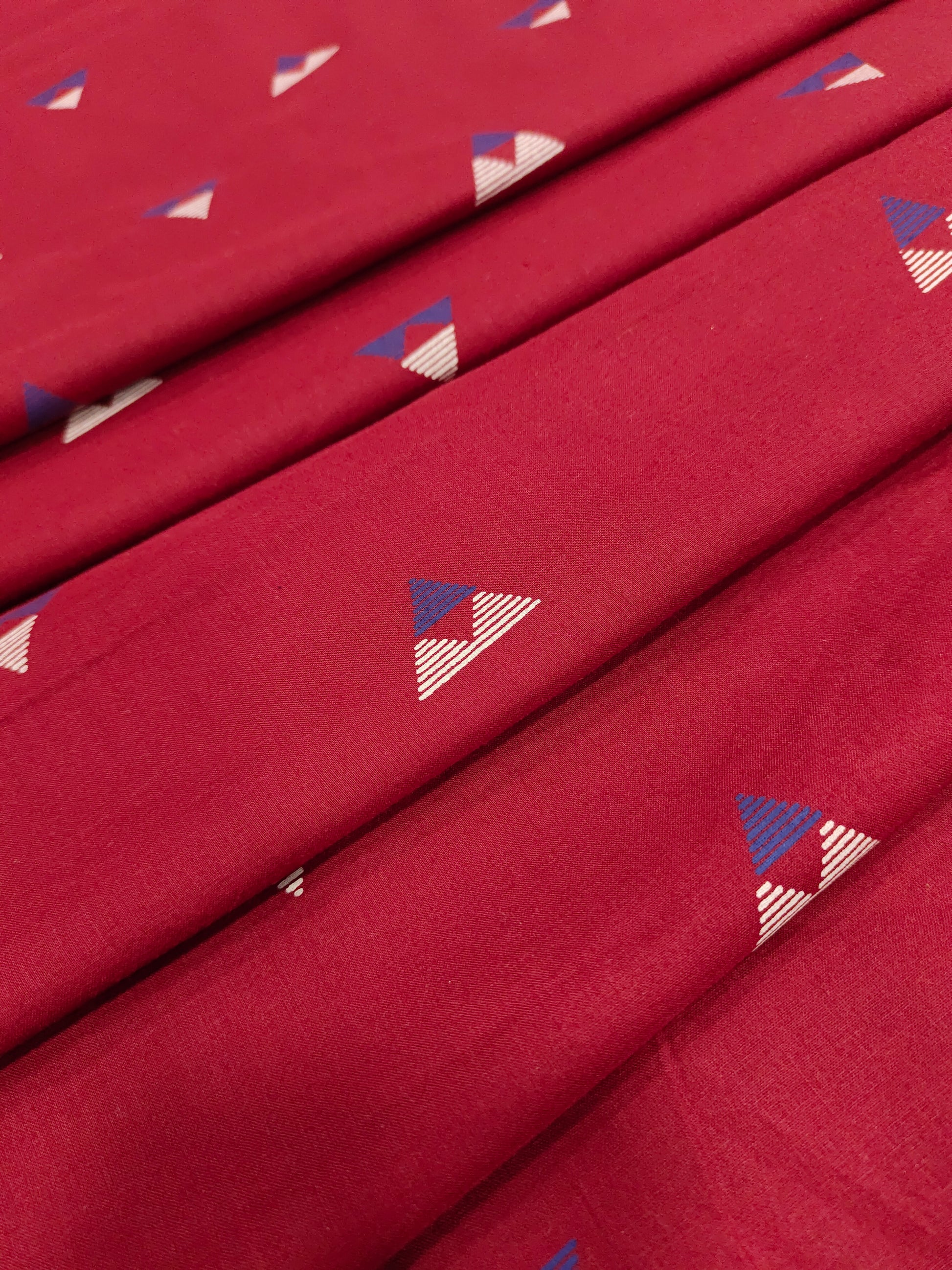 Maroon cotton fabric triangle print with off white and blue