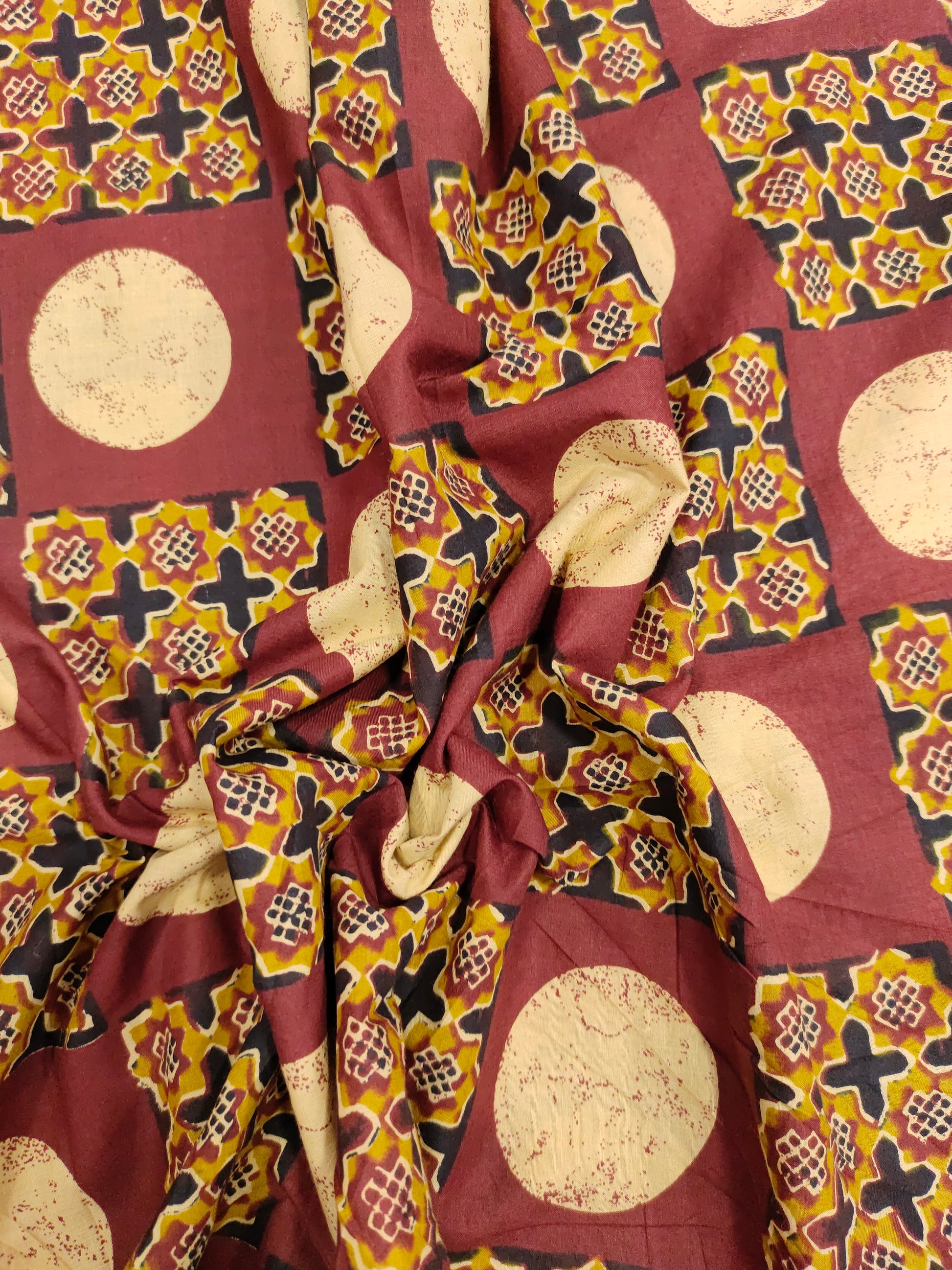 Cotton screen print maroon fabric with yellow white and black