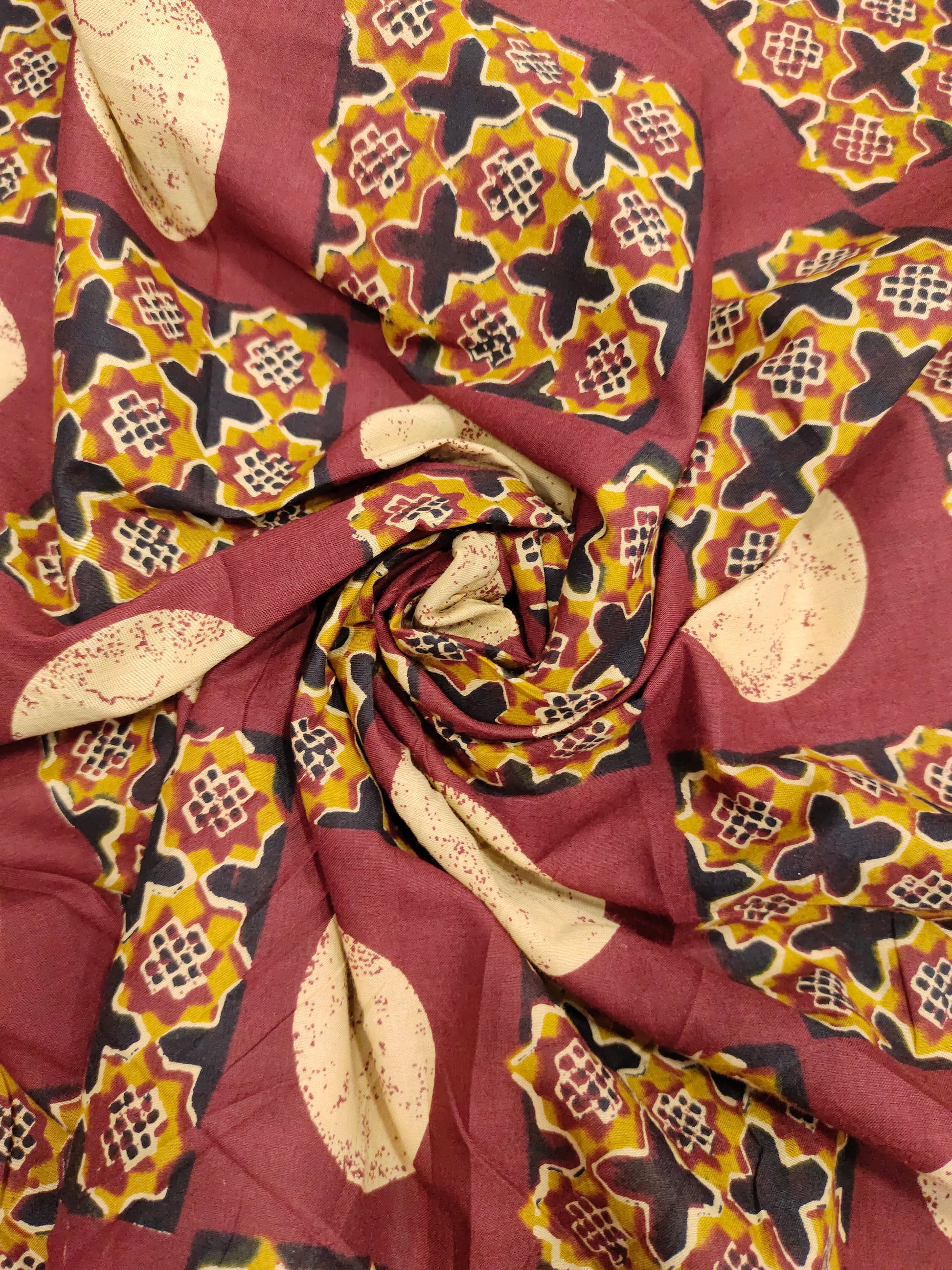 Cotton screen print maroon fabric with yellow white and black
