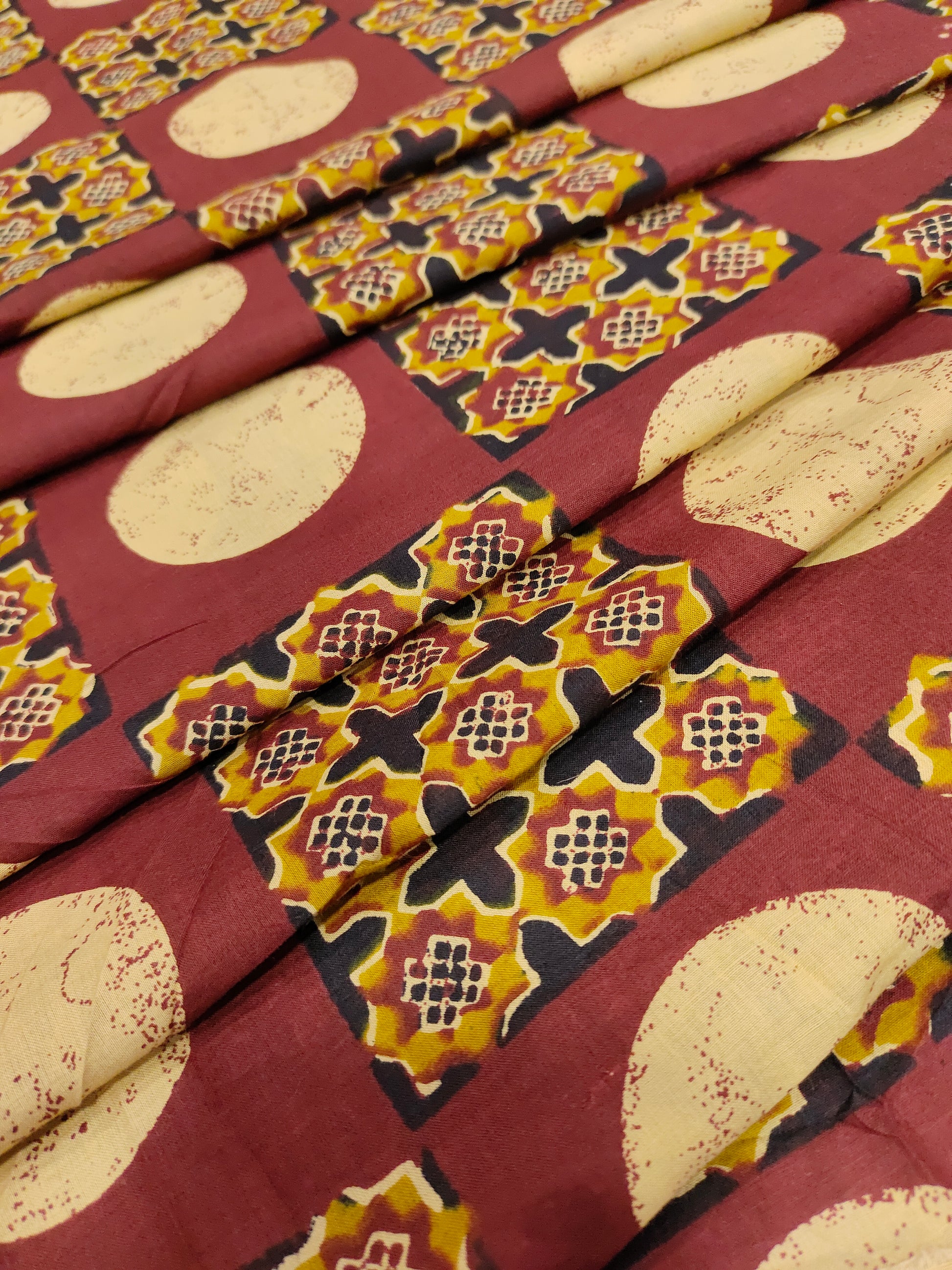 Cotton screen print maroon fabric with yellow white and black