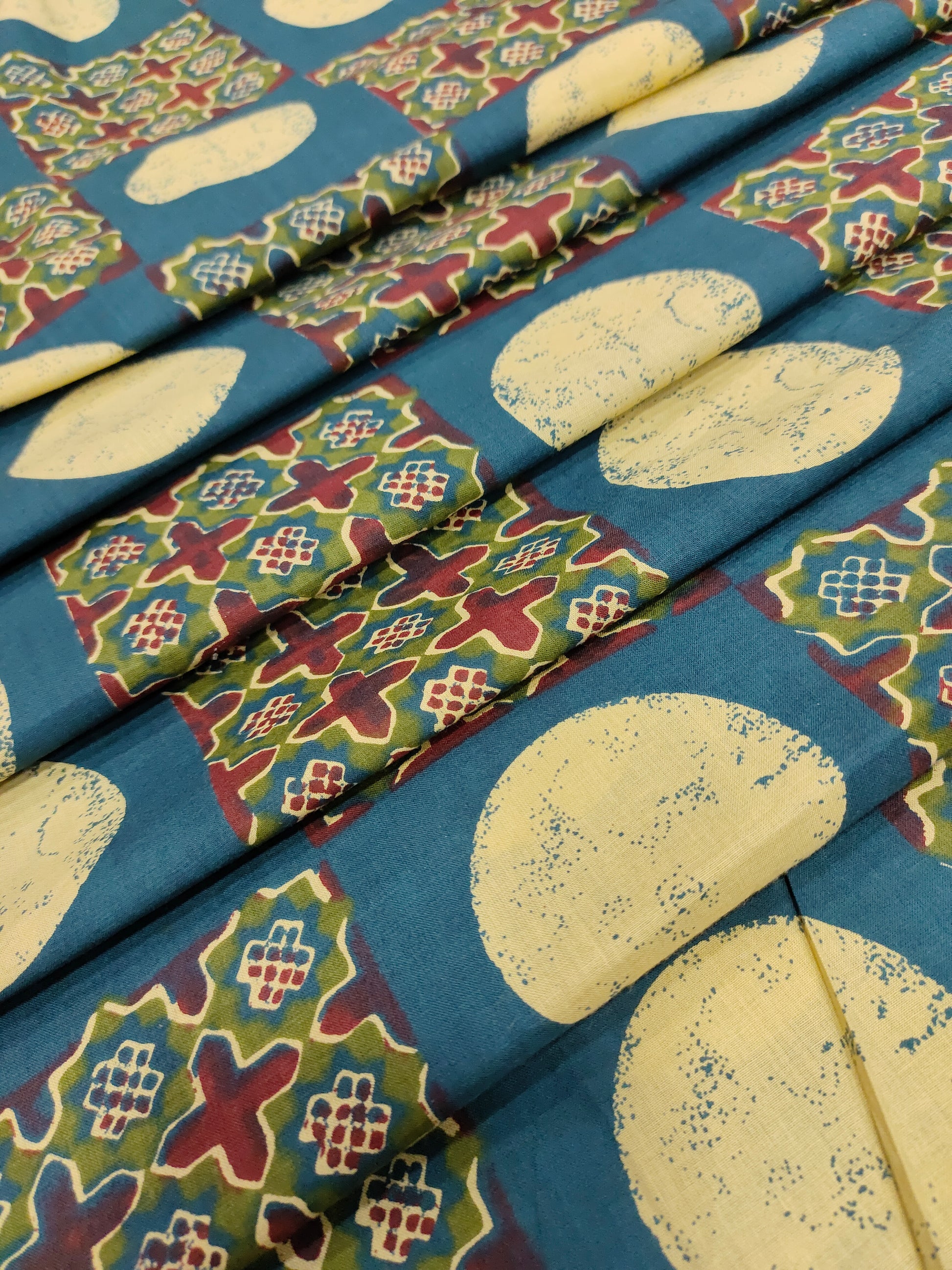 Cotton screen print blue fabric with maroon green and off white