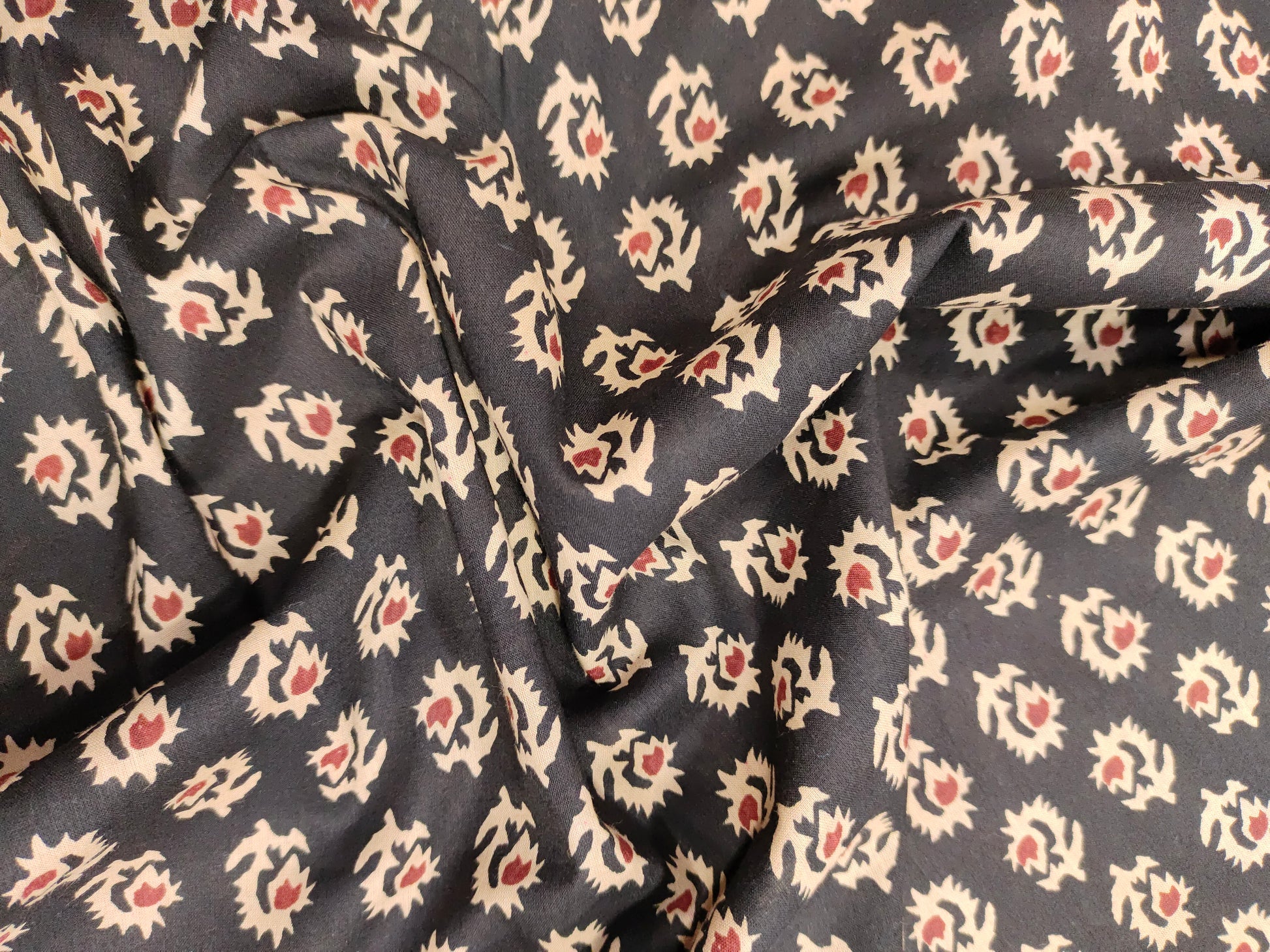 cotton fabric black with beige & rust motifs