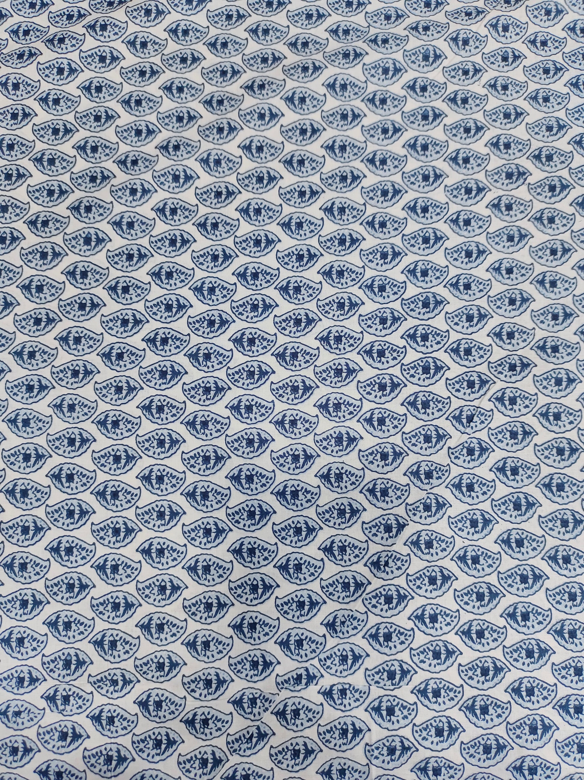 White color fabric with blue leaves print