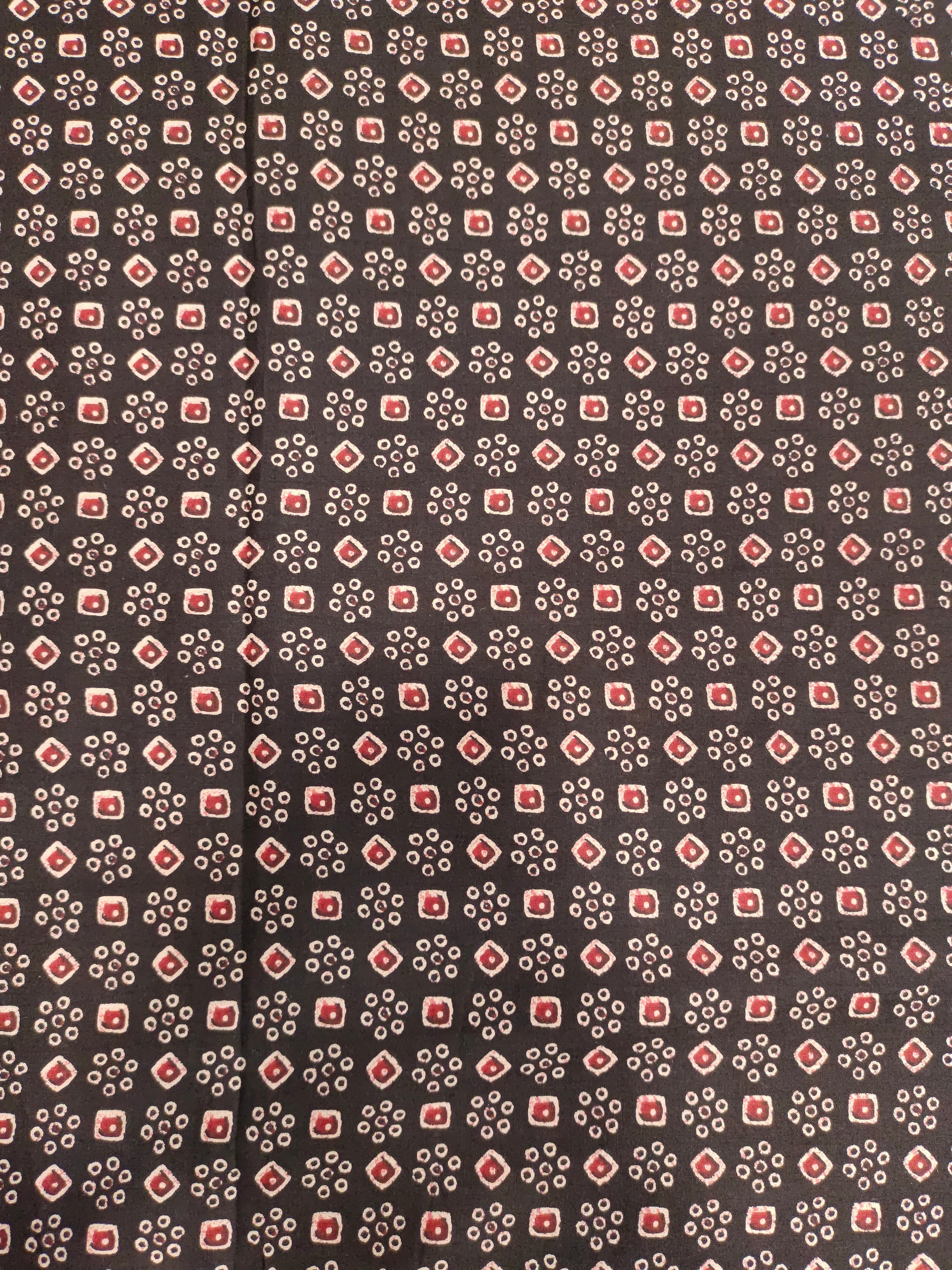 Black fabric with maroon and beige print