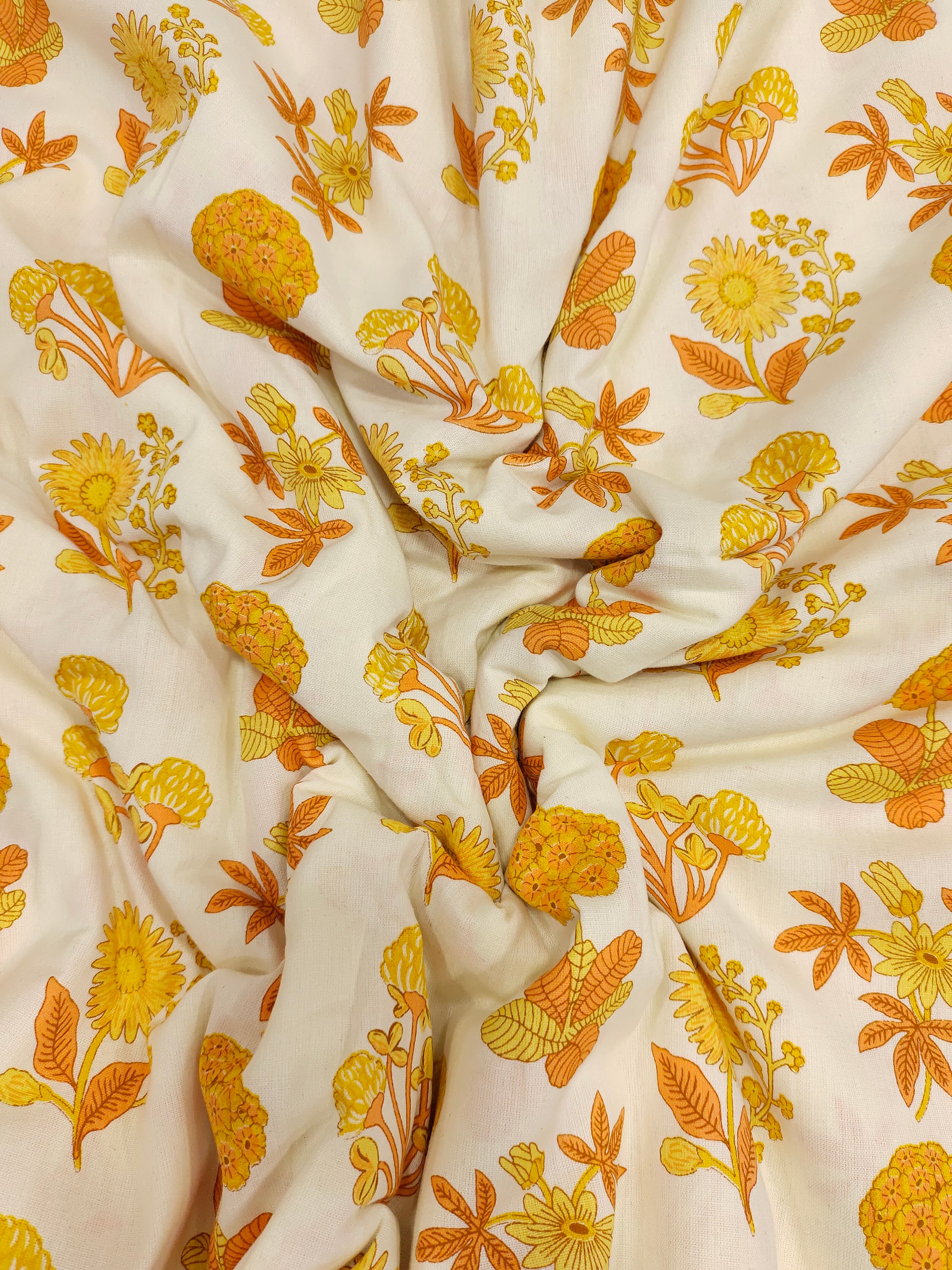 Cotton flex printed with orange and yellow floral print.