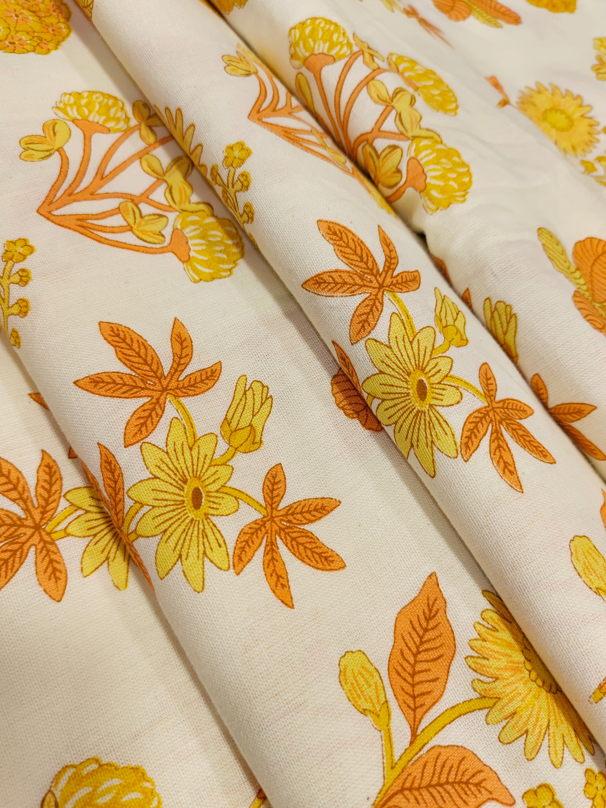 Cotton flex printed with orange and yellow floral print.