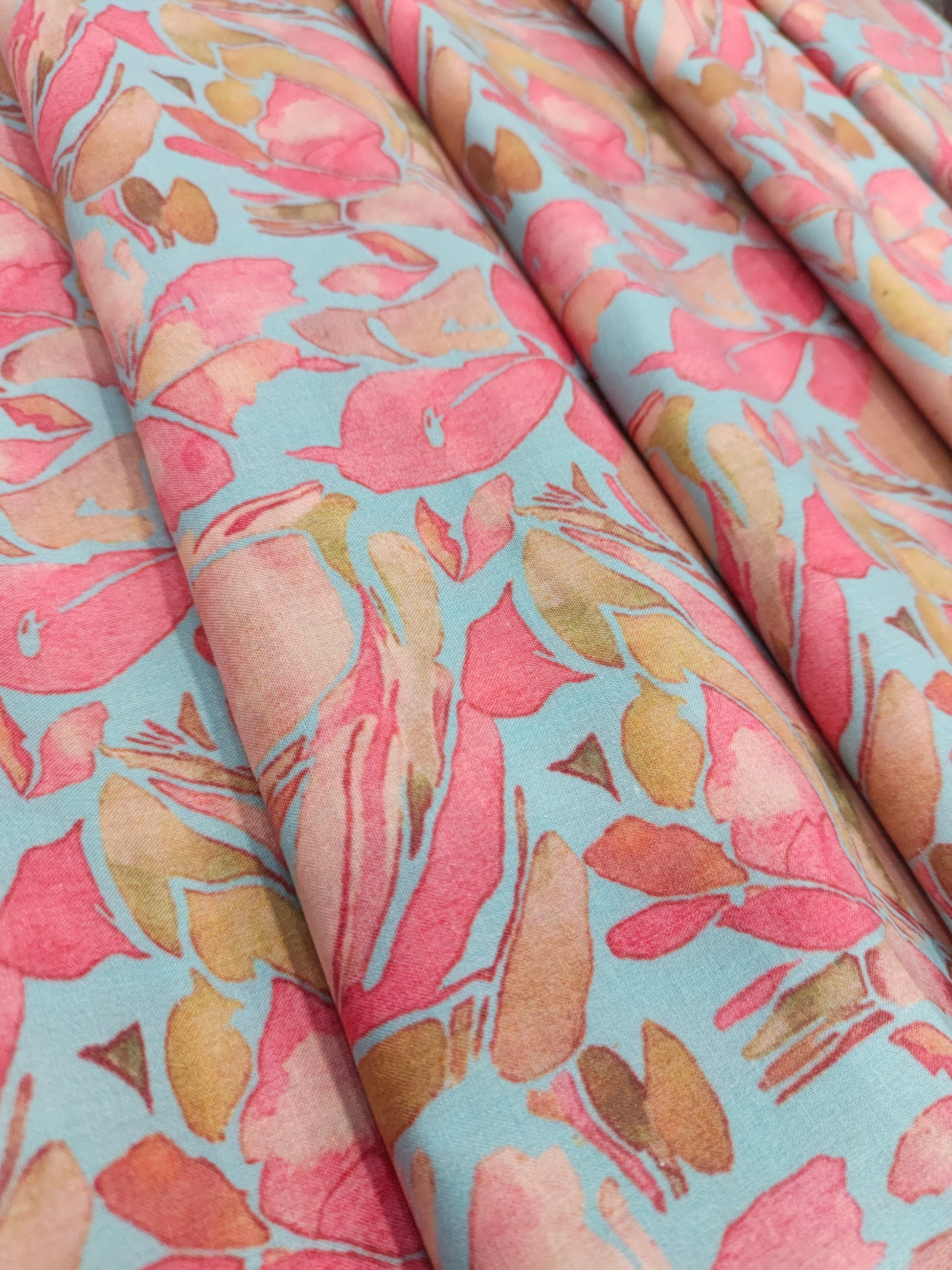 Cotton digital print on blueish green fabric withtomato and peach color.