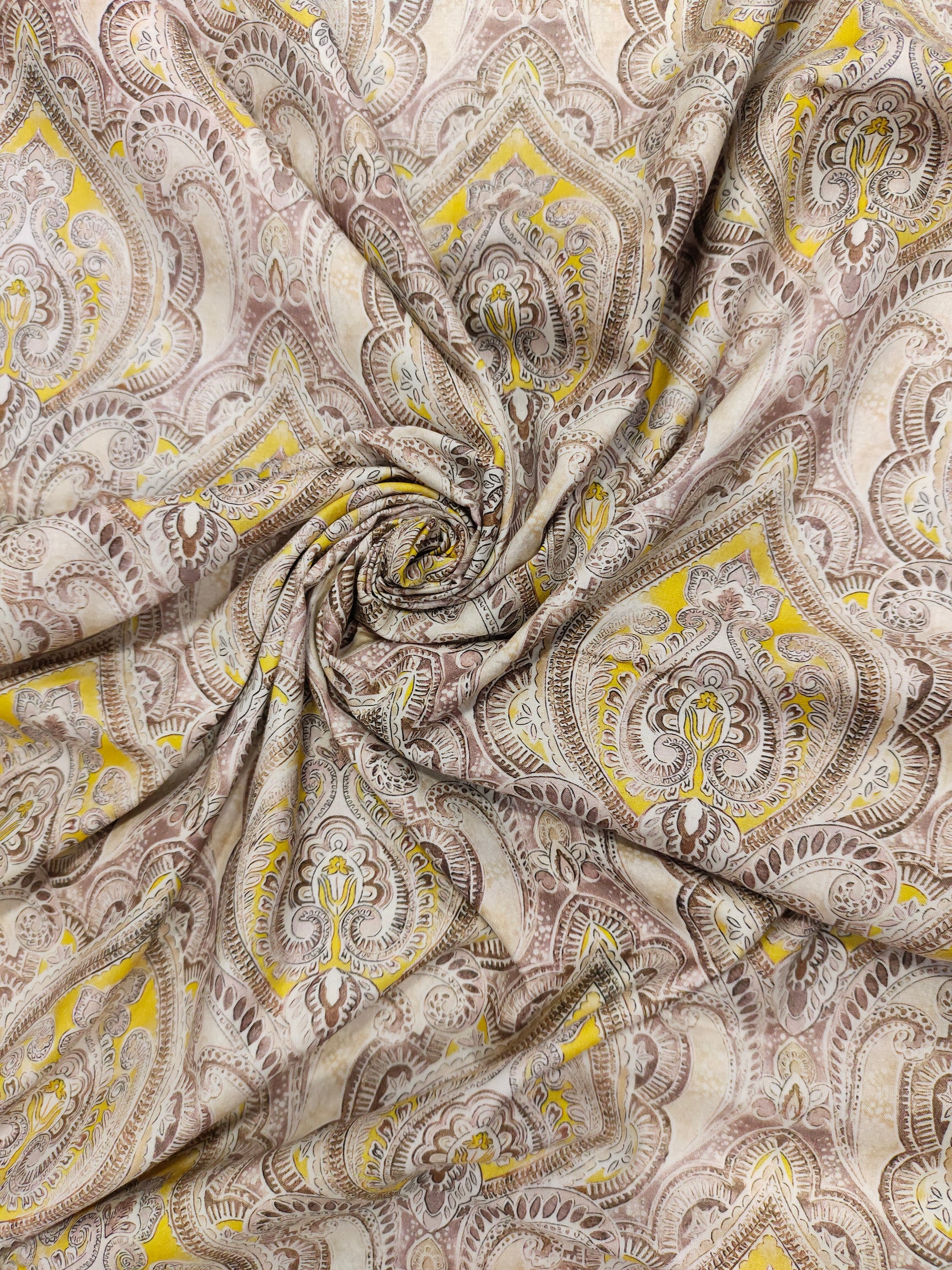 Pure cotton digital print with yellow and brown leaves pattern.