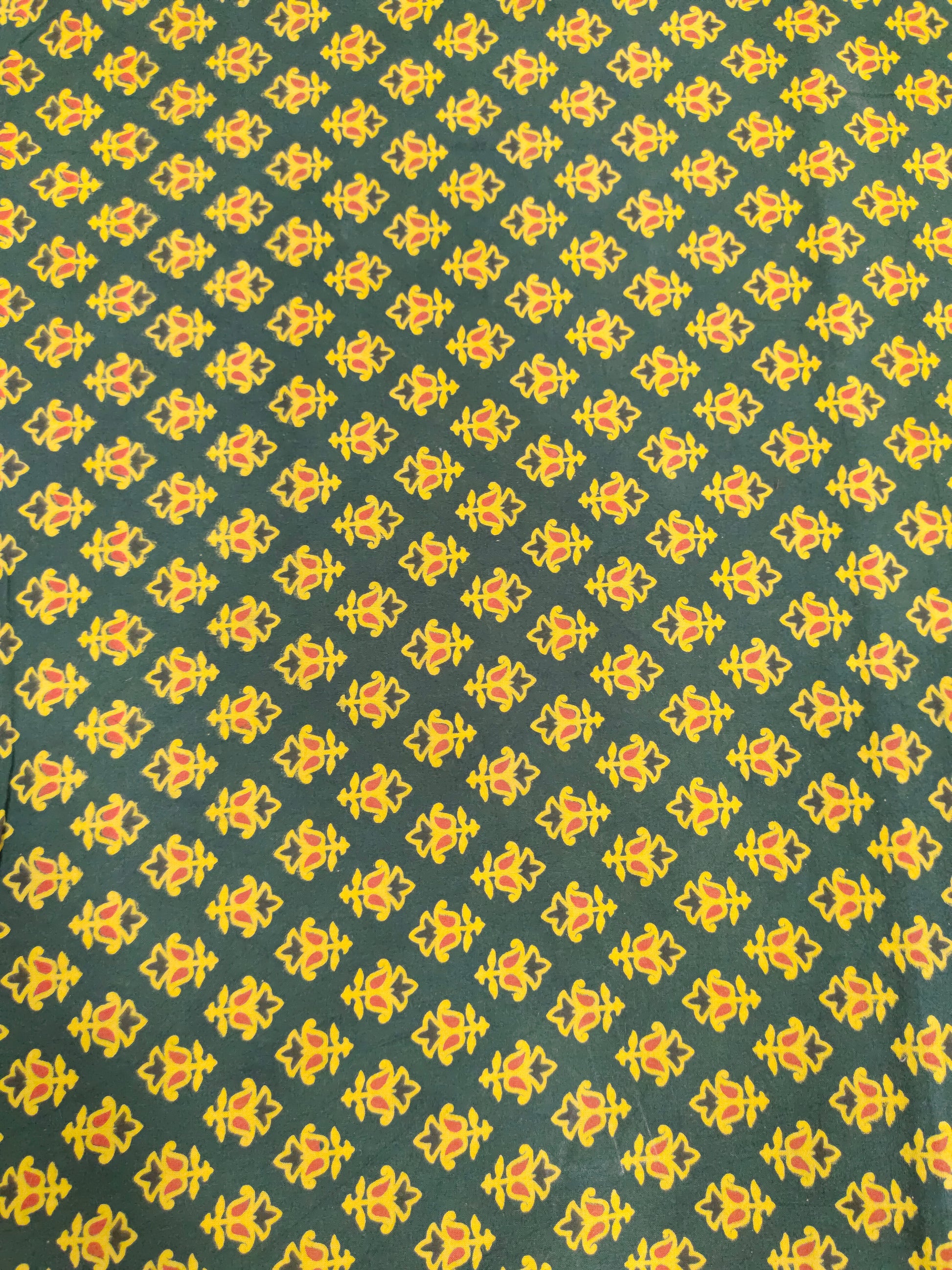 Green and yellow pure cotton ajrak print in small butti.