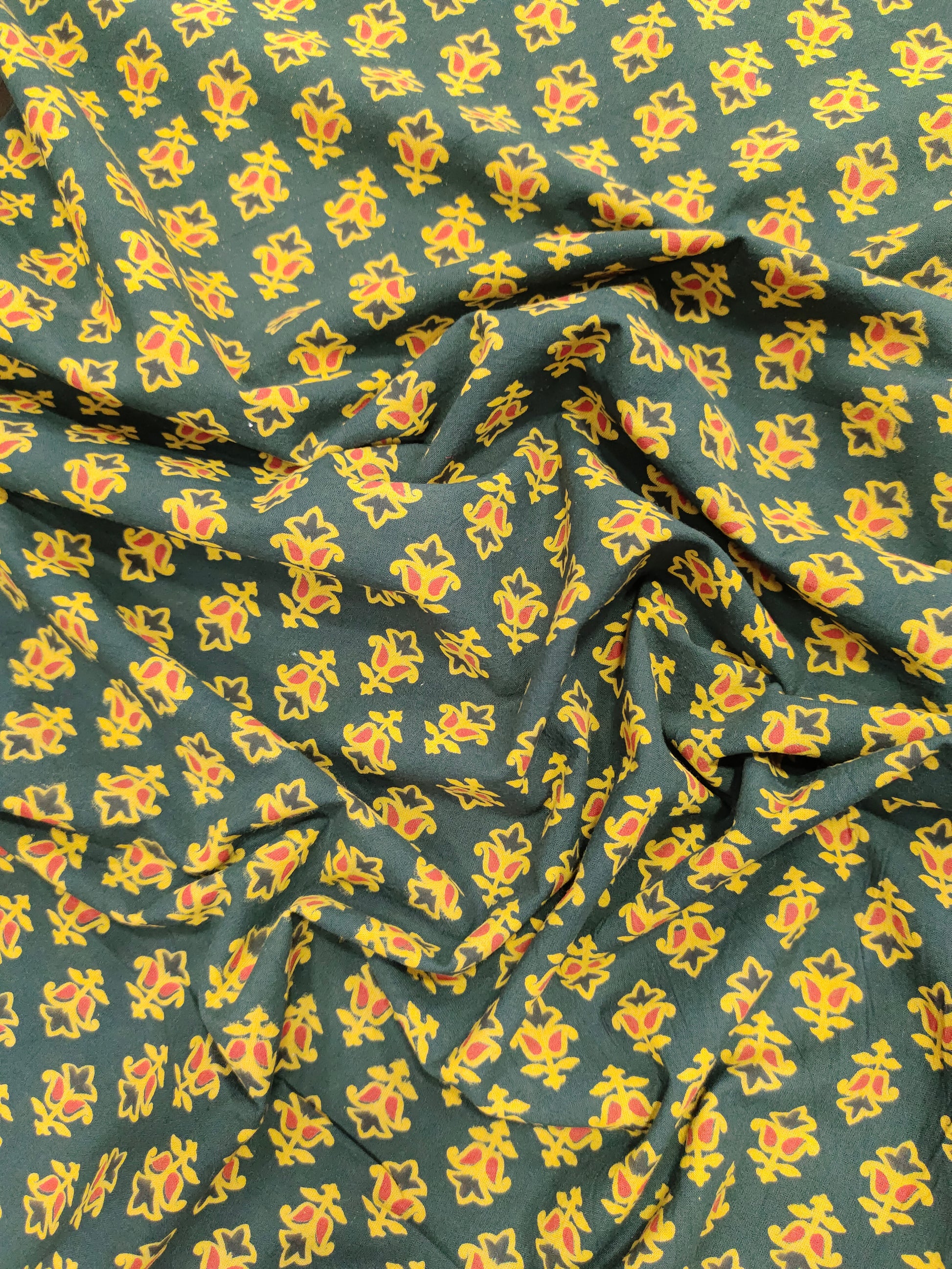 Green and yellow pure cotton ajrak print in small butti.