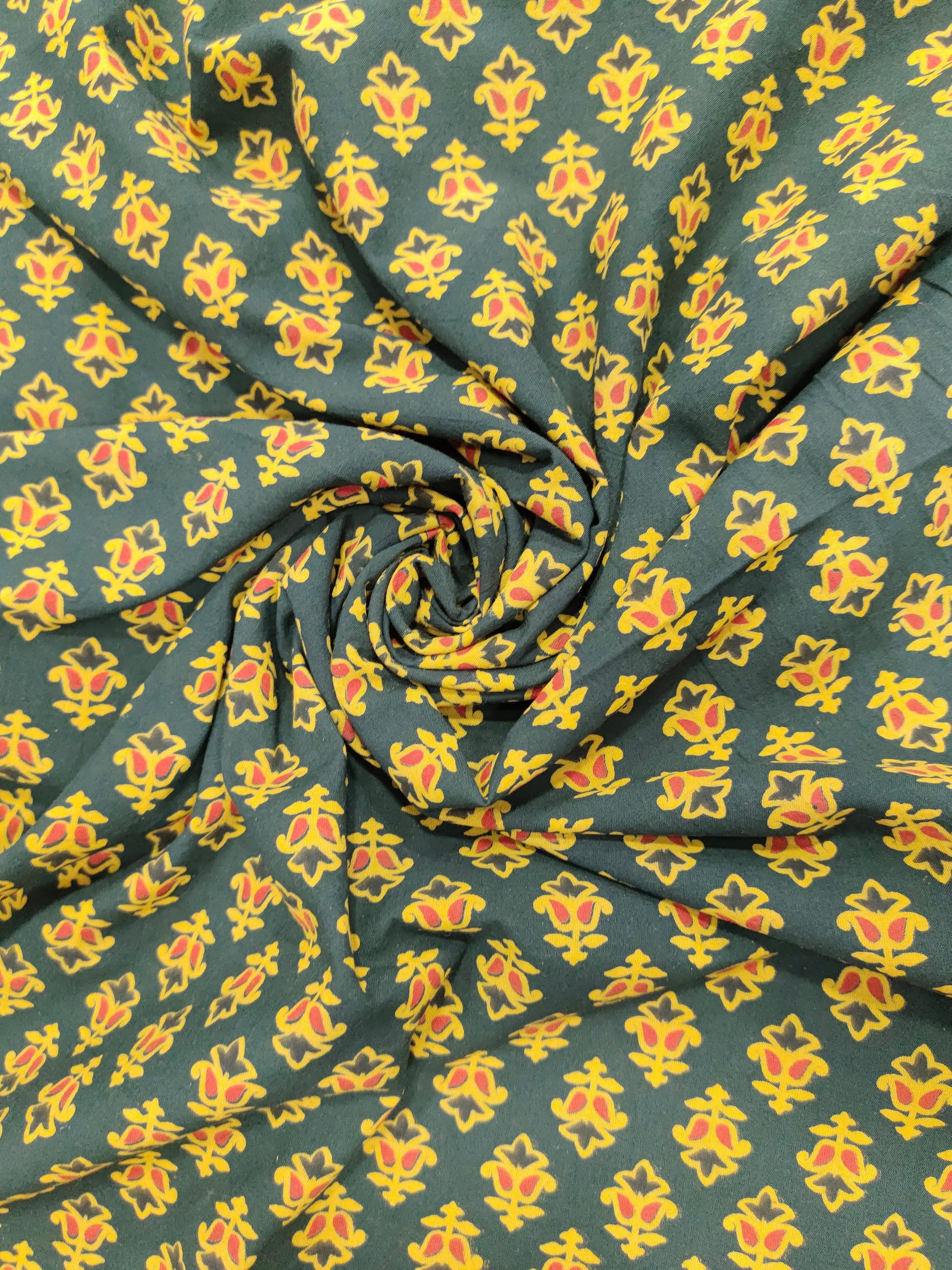 Green and yellow pure cotton ajrak print in small butti.