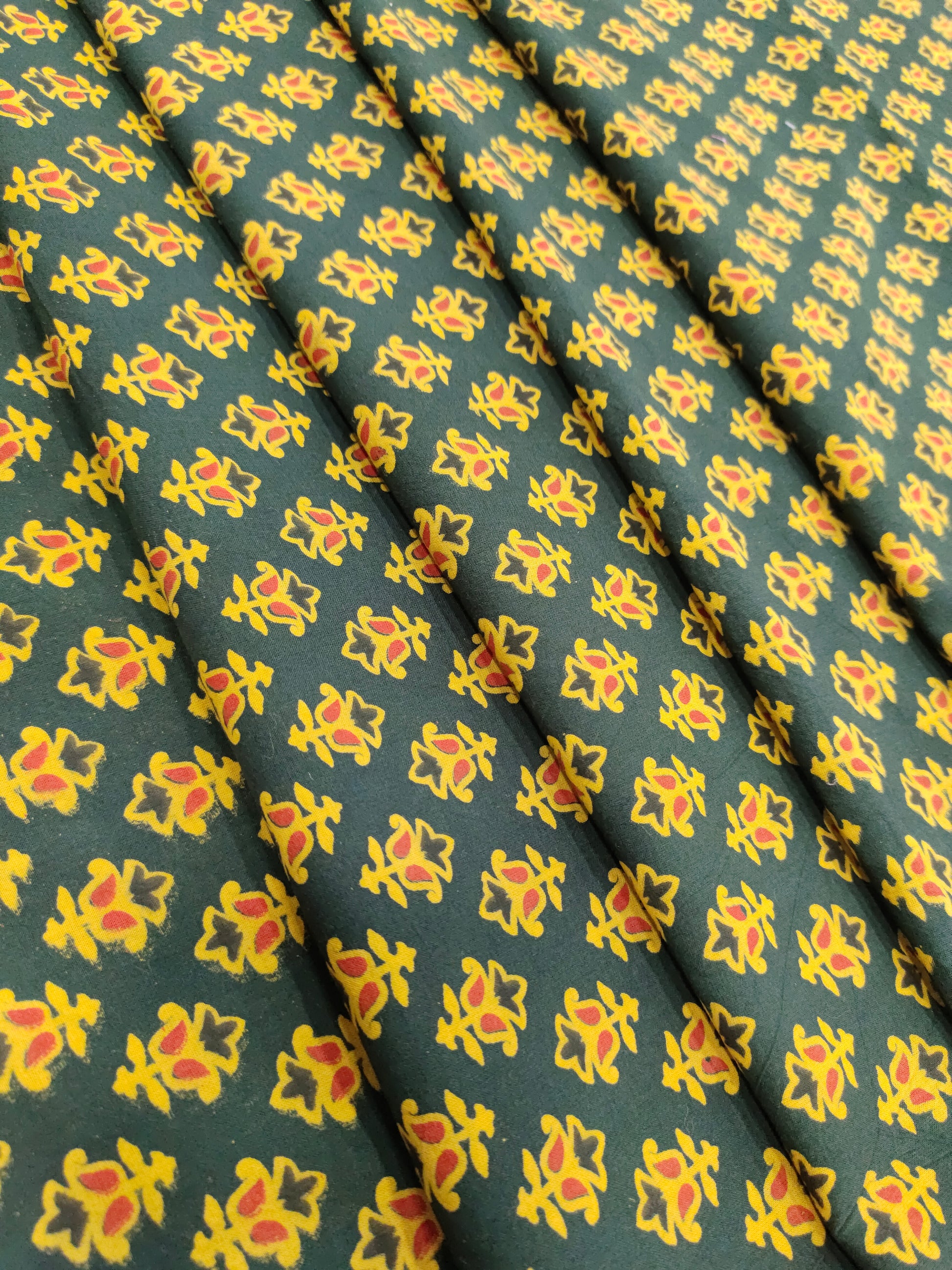 Green and yellow pure cotton ajrak print in small butti.