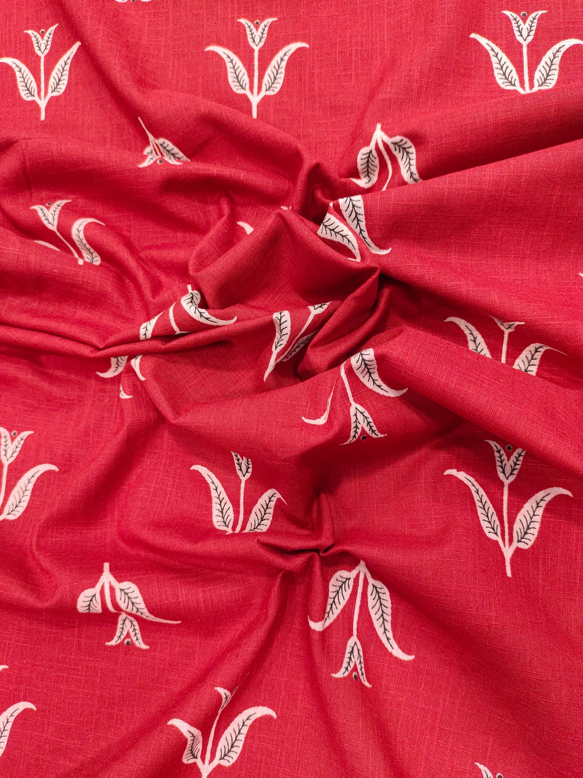 Red cotton slub fabric with black butti print.