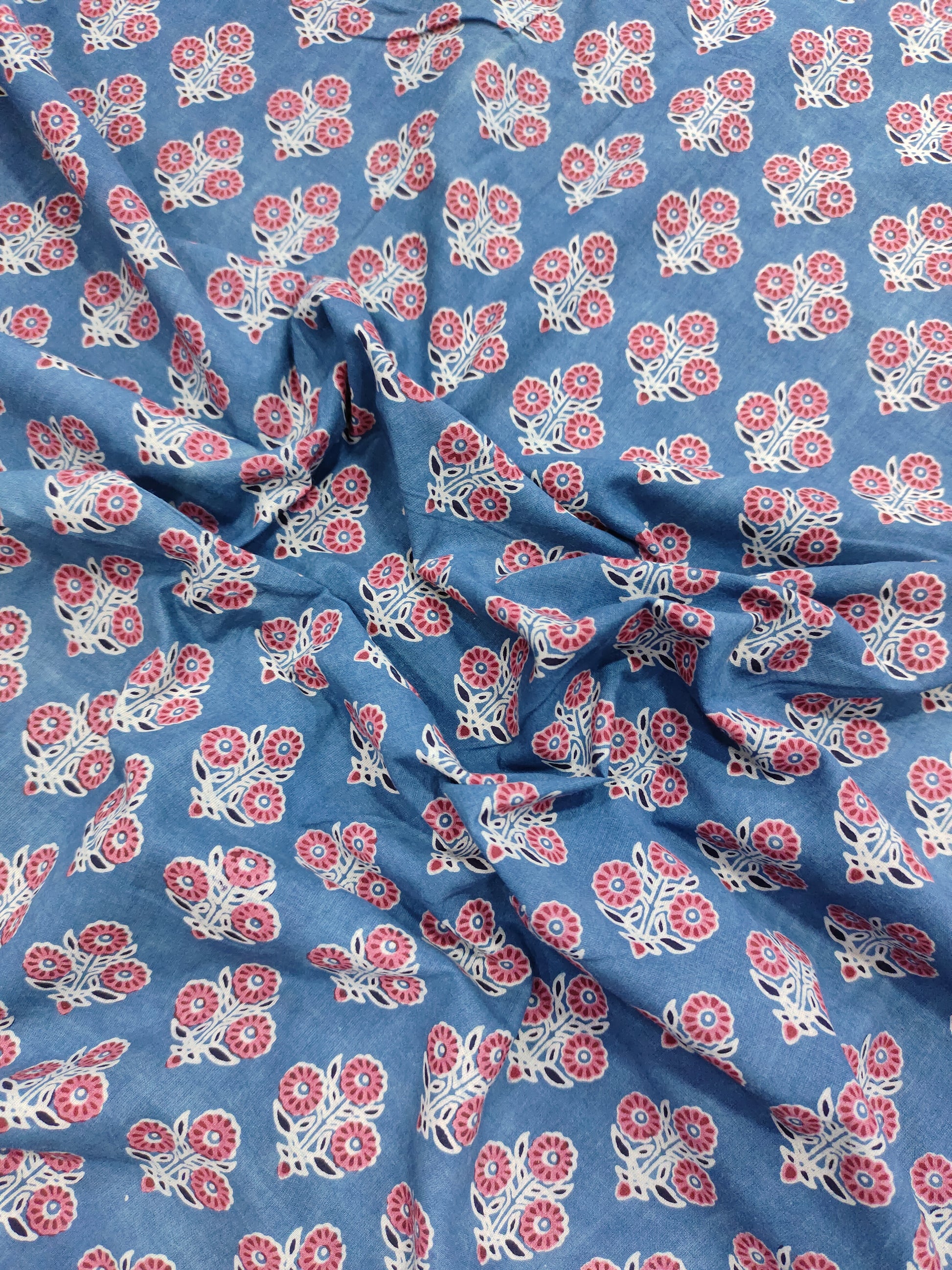 Blue ajrak print with red and white motifs.
