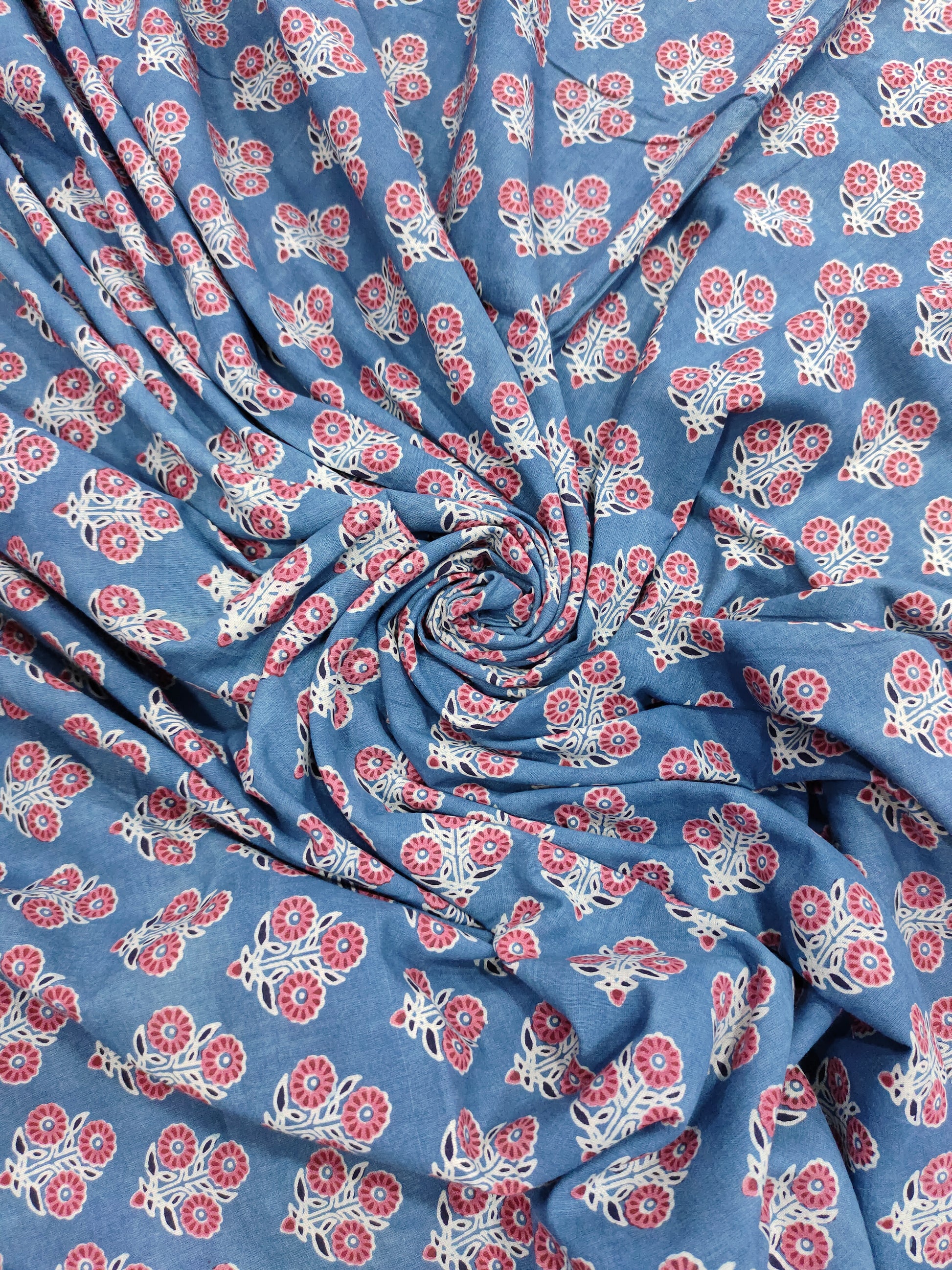 Blue ajrak print with red and white motifs.