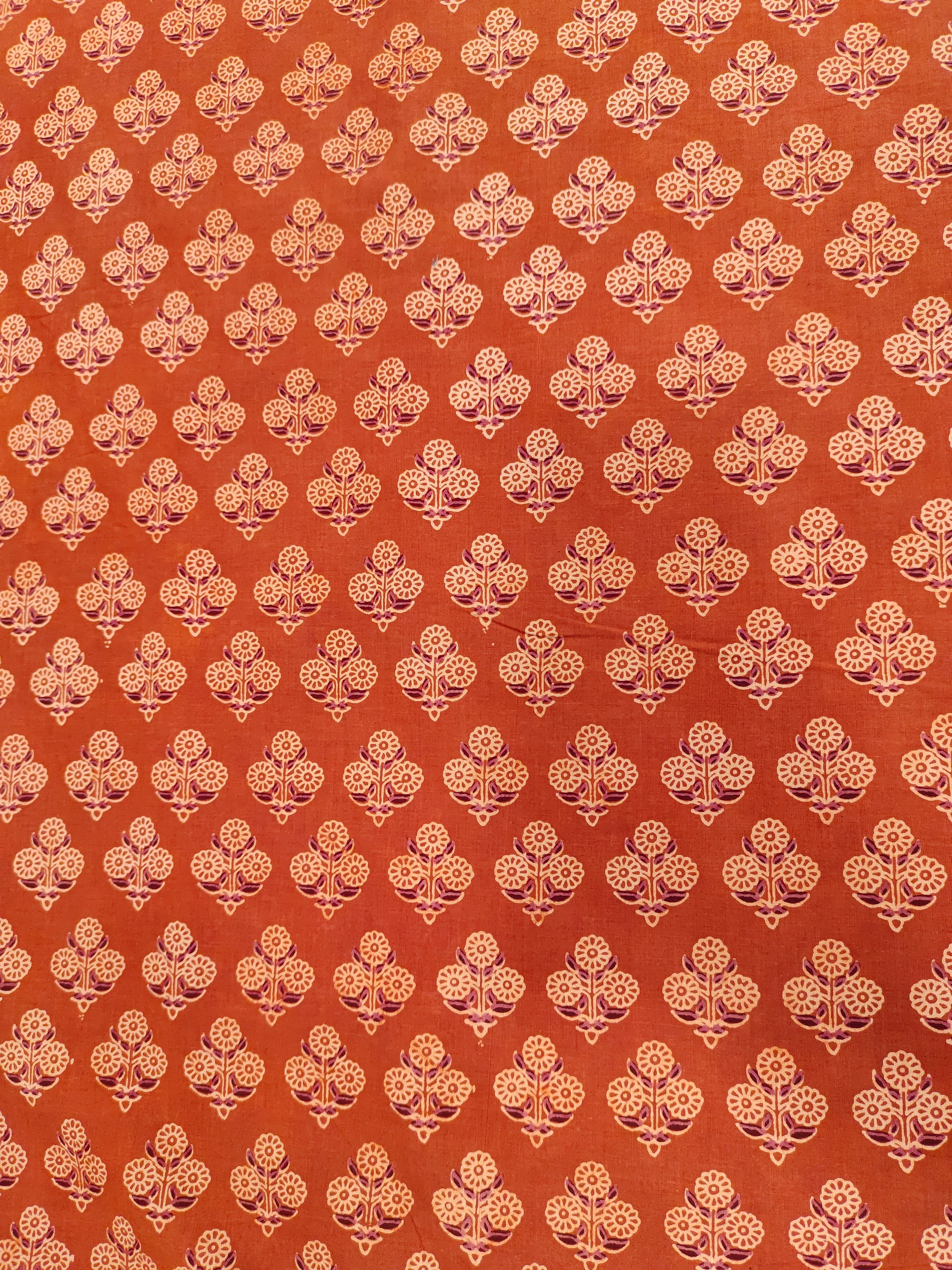 Orangish rust ajrak print with beige and maroon.