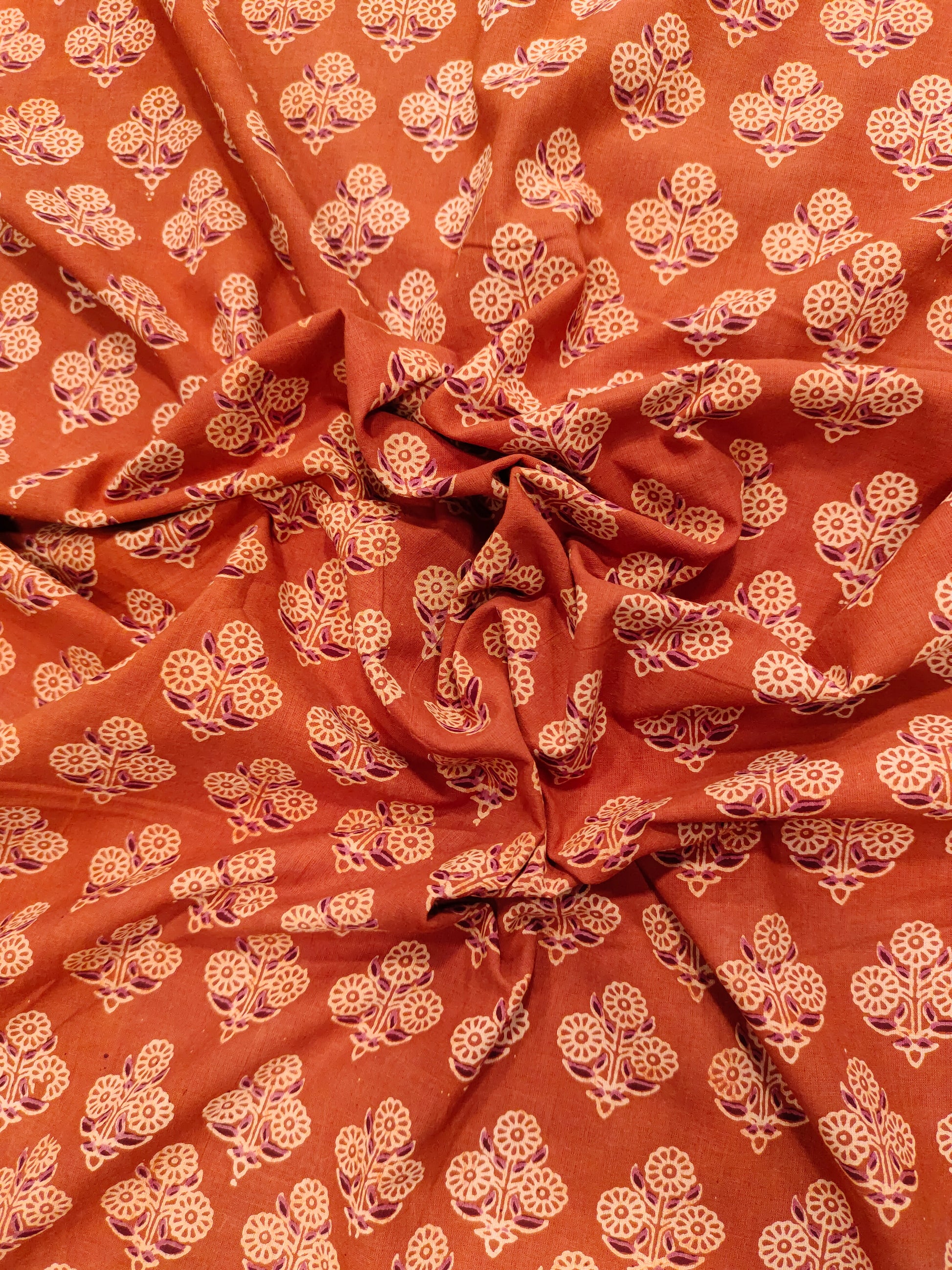 Orangish rust ajrak print with beige and maroon.