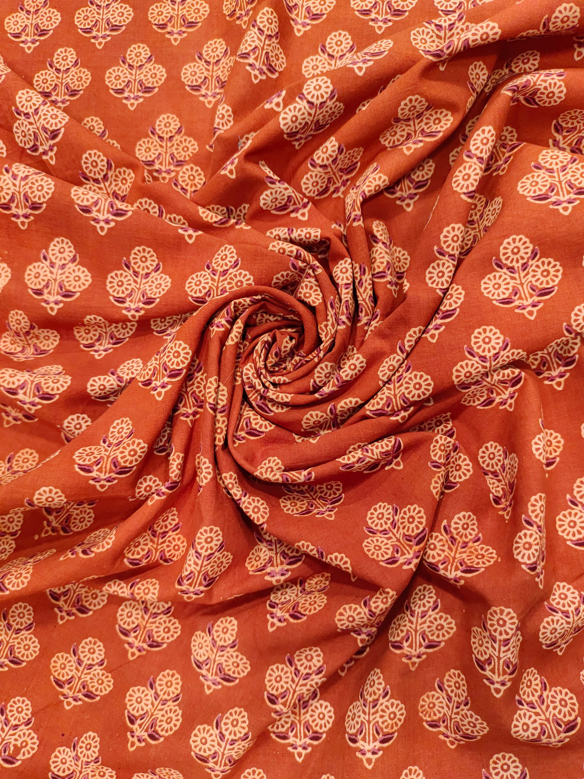 Orangish rust ajrak print with beige and maroon.