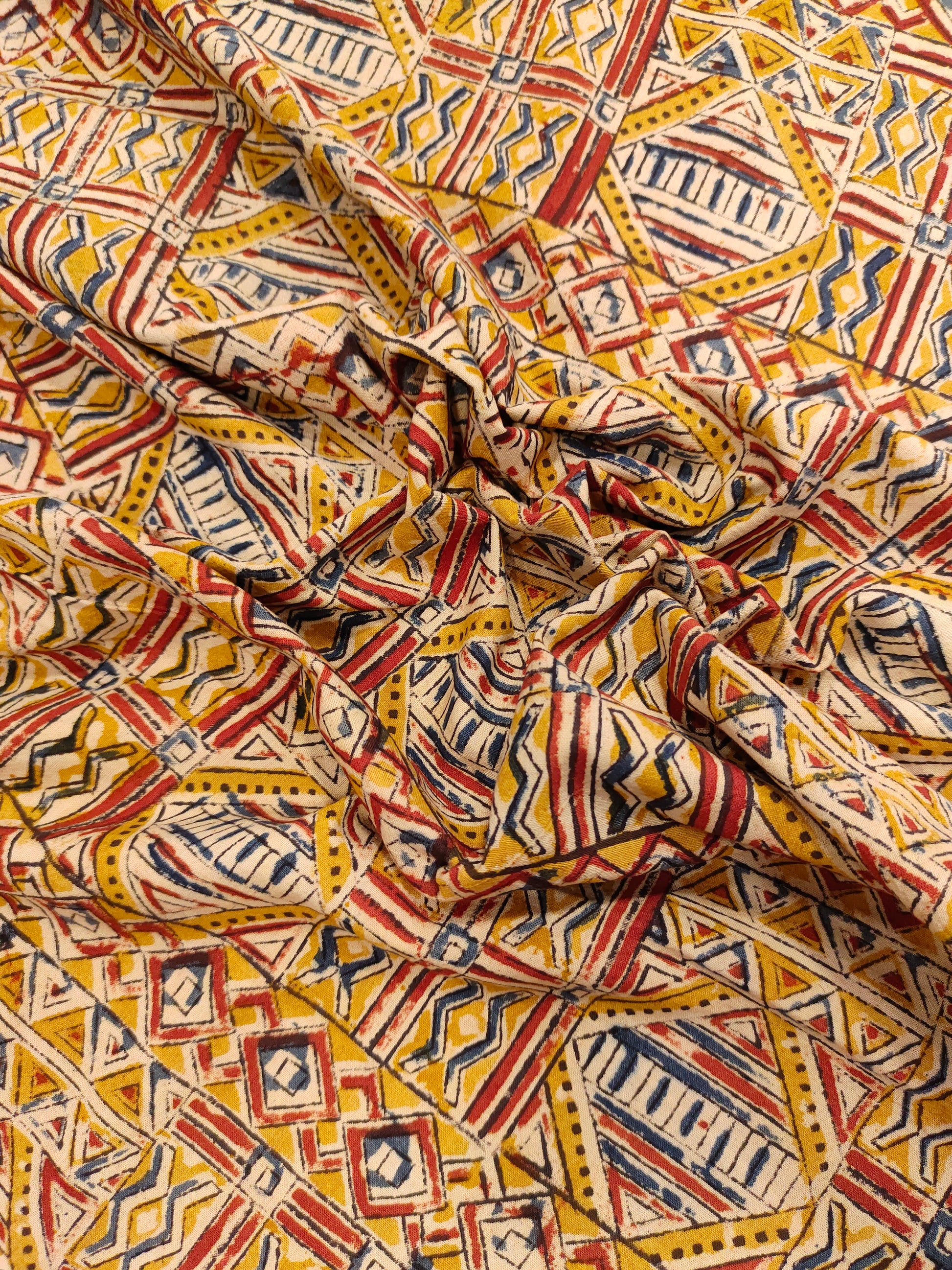 Dark mustard kalamkari printed with red and blue.