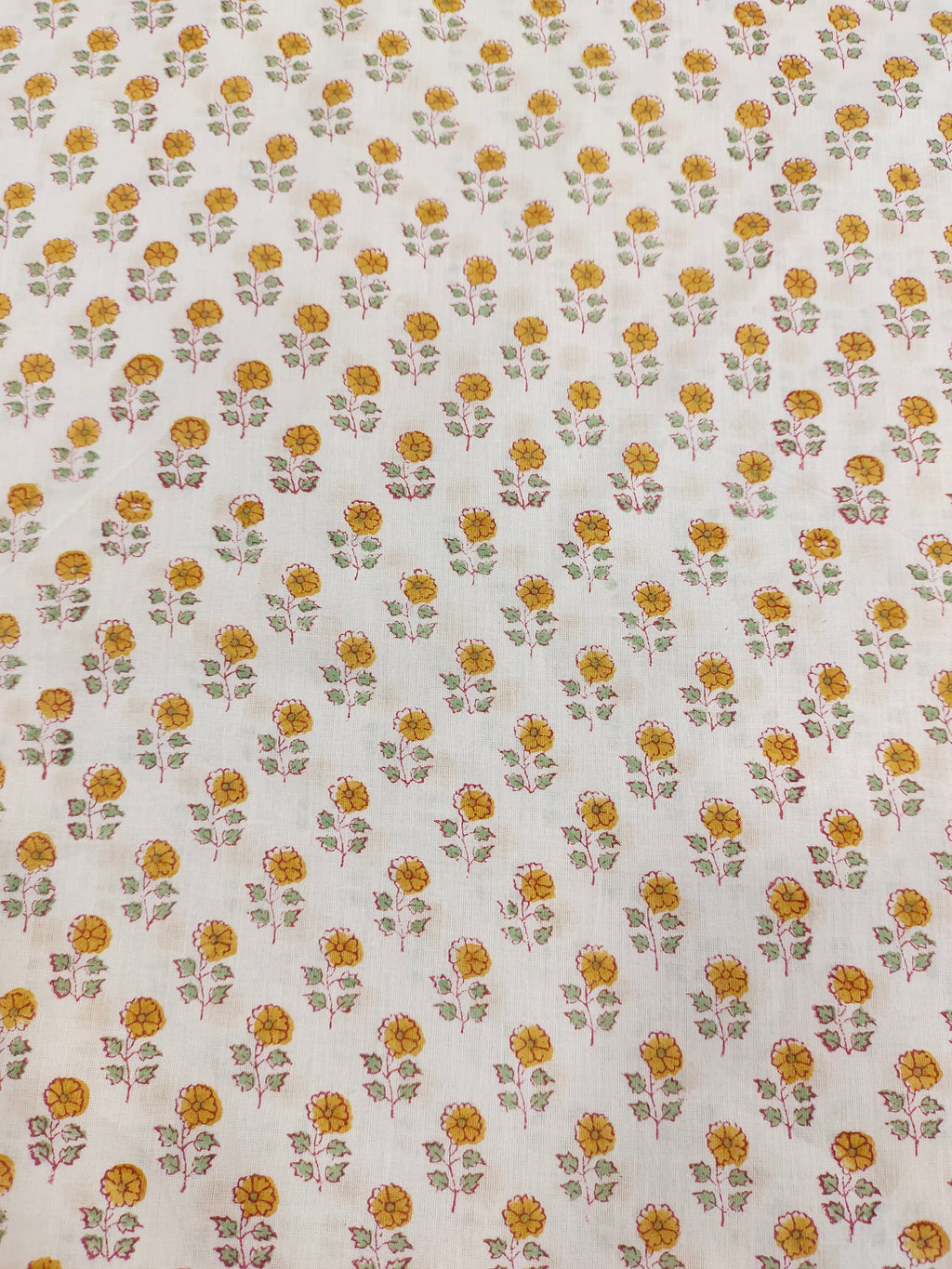 White cotton fabric with mustard and green handblock print