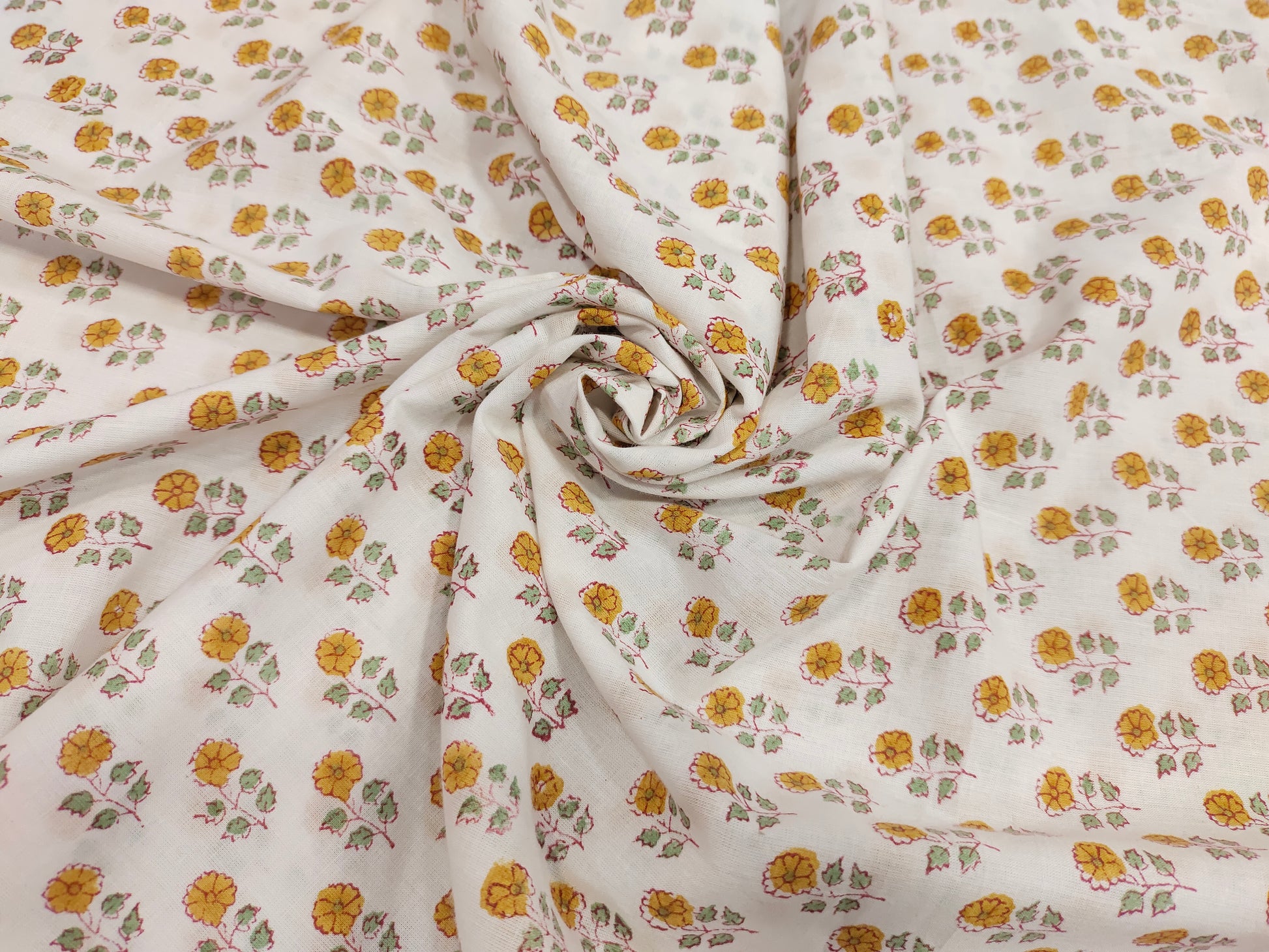 White cotton fabric with mustard and green handblock print