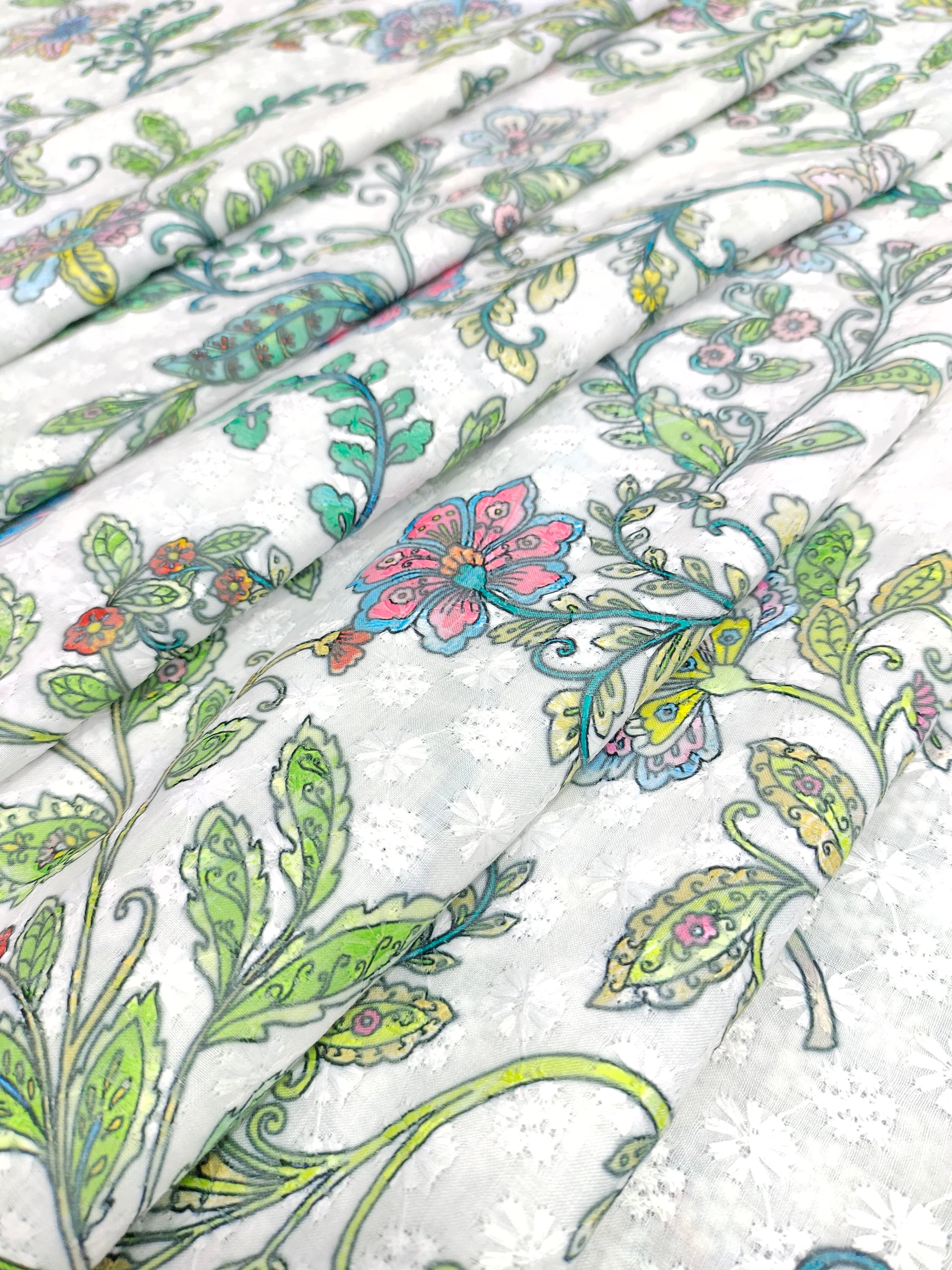White embroidered fabric digital print with blue pink and green