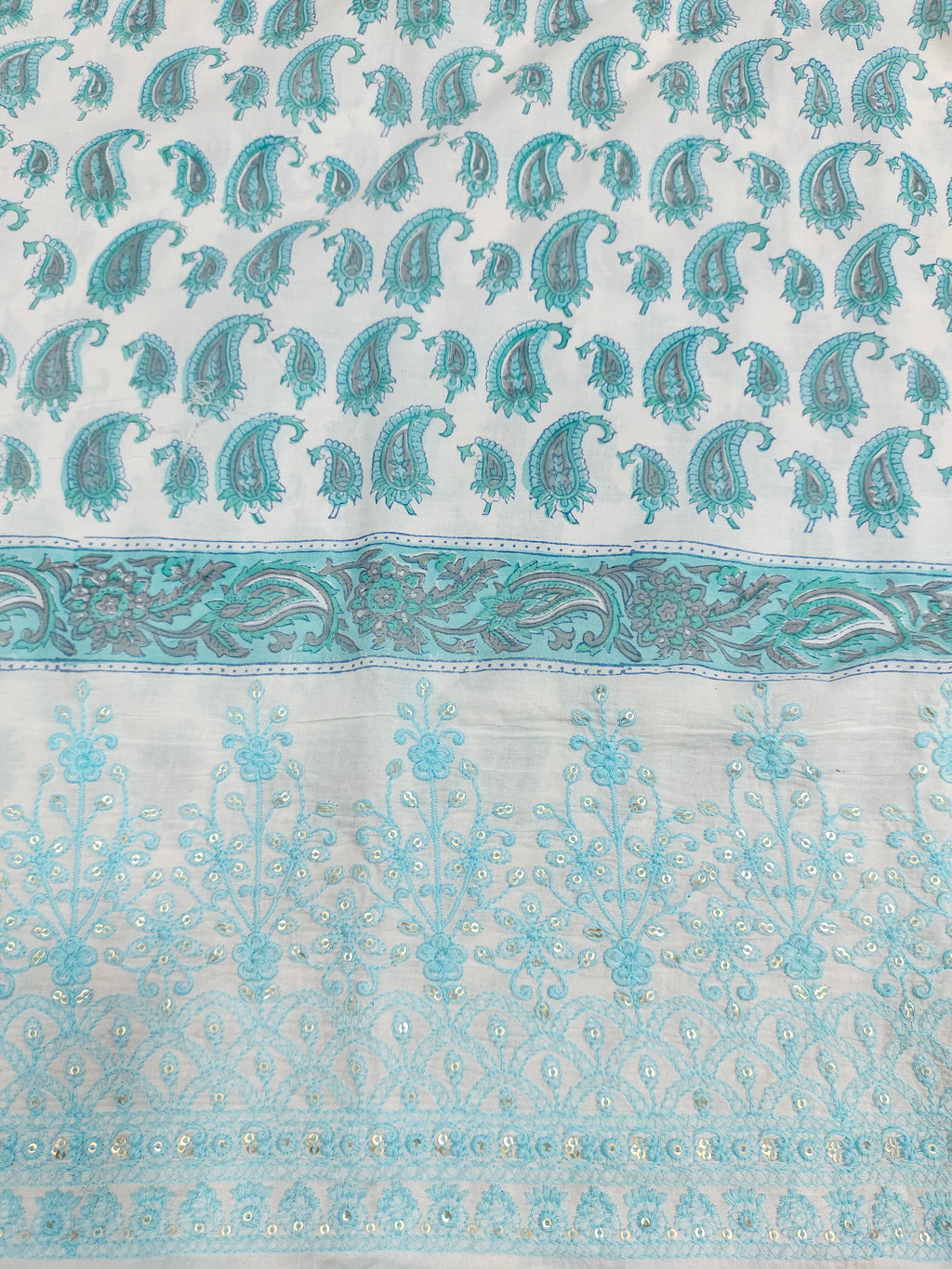 White fabric with blue handblock print and added with schiffli daman