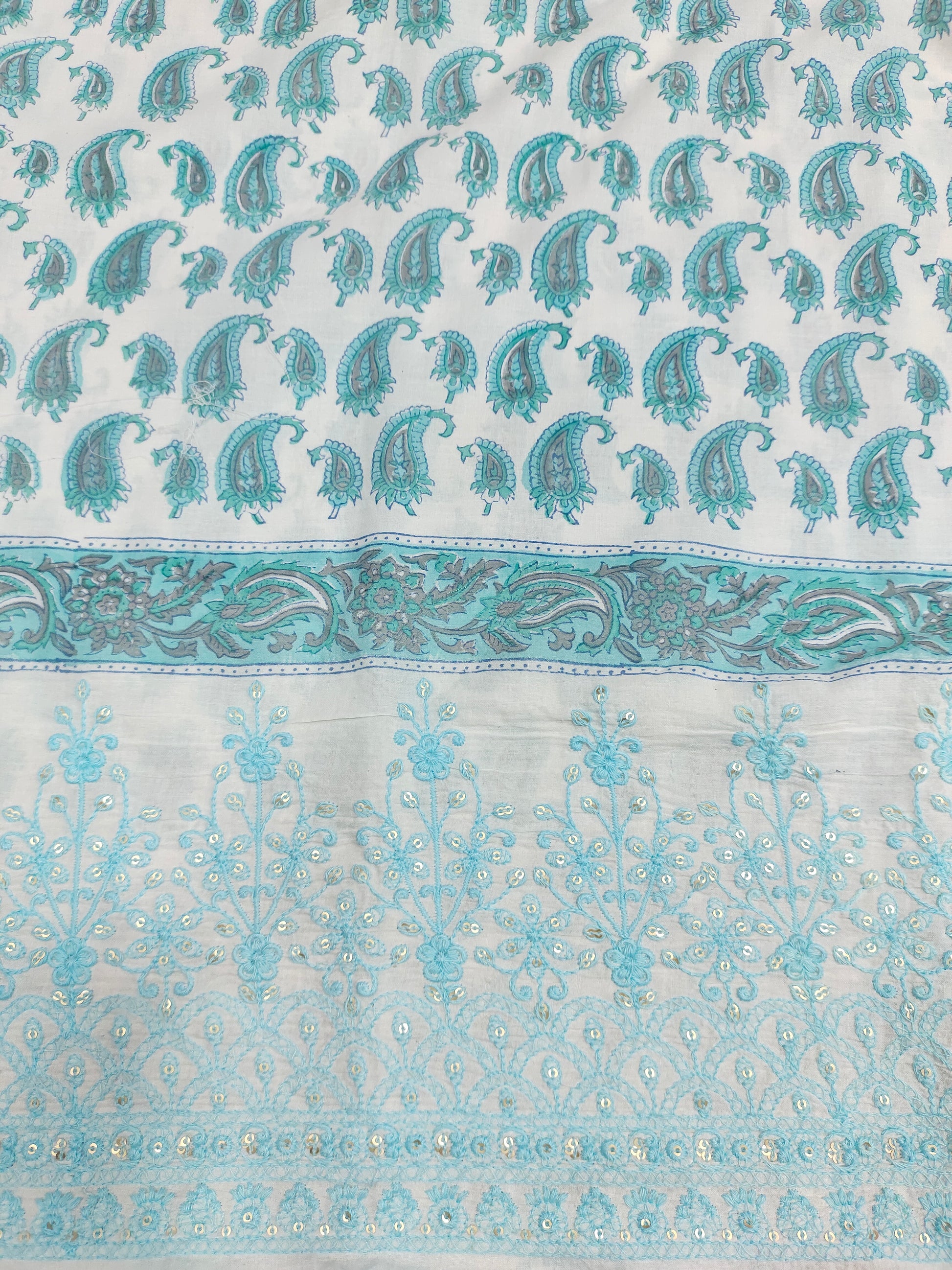 White fabric with blue handblock print and added with schiffli daman