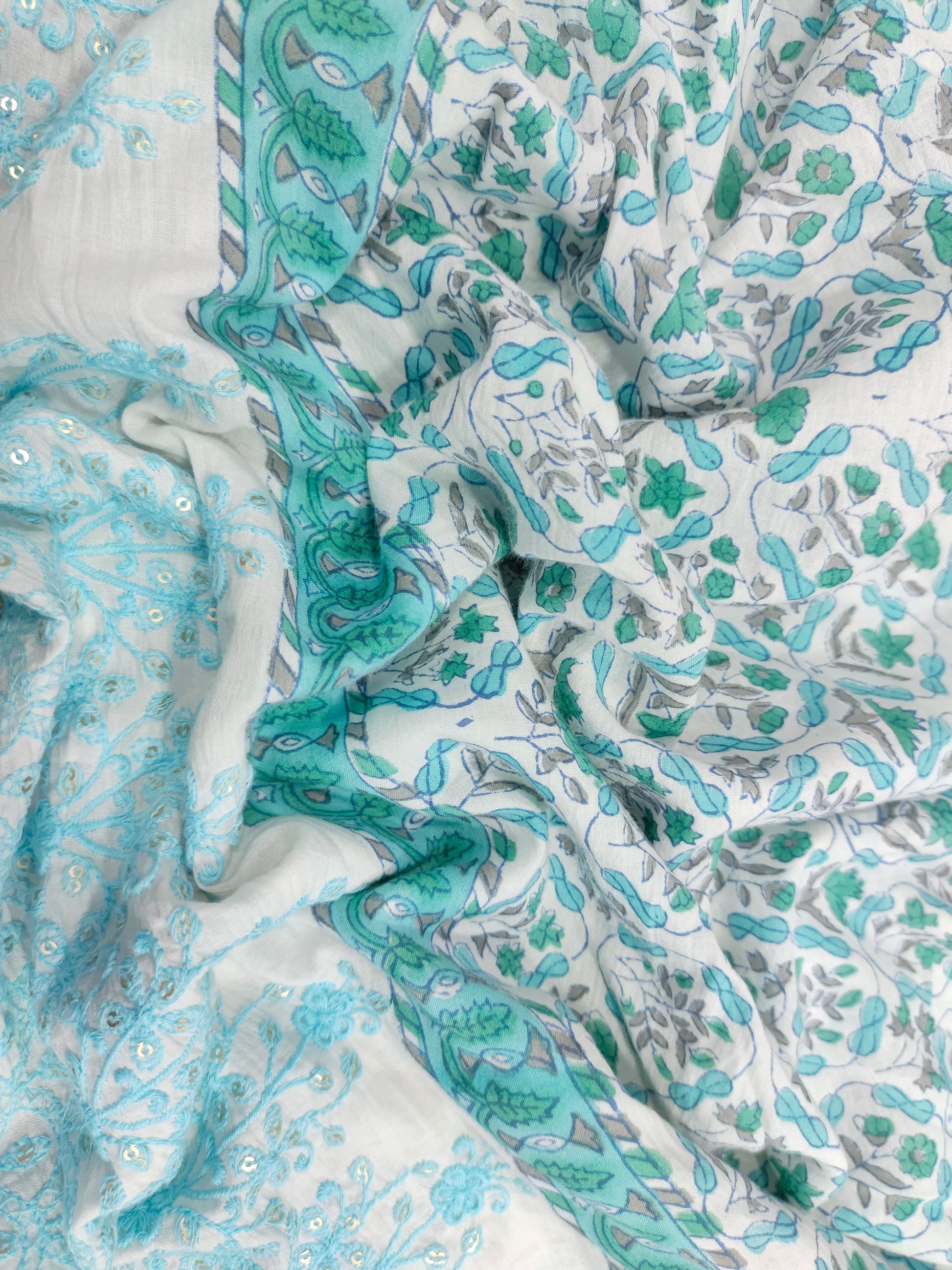 White fabric with blue handblock print and added with schiffli daman