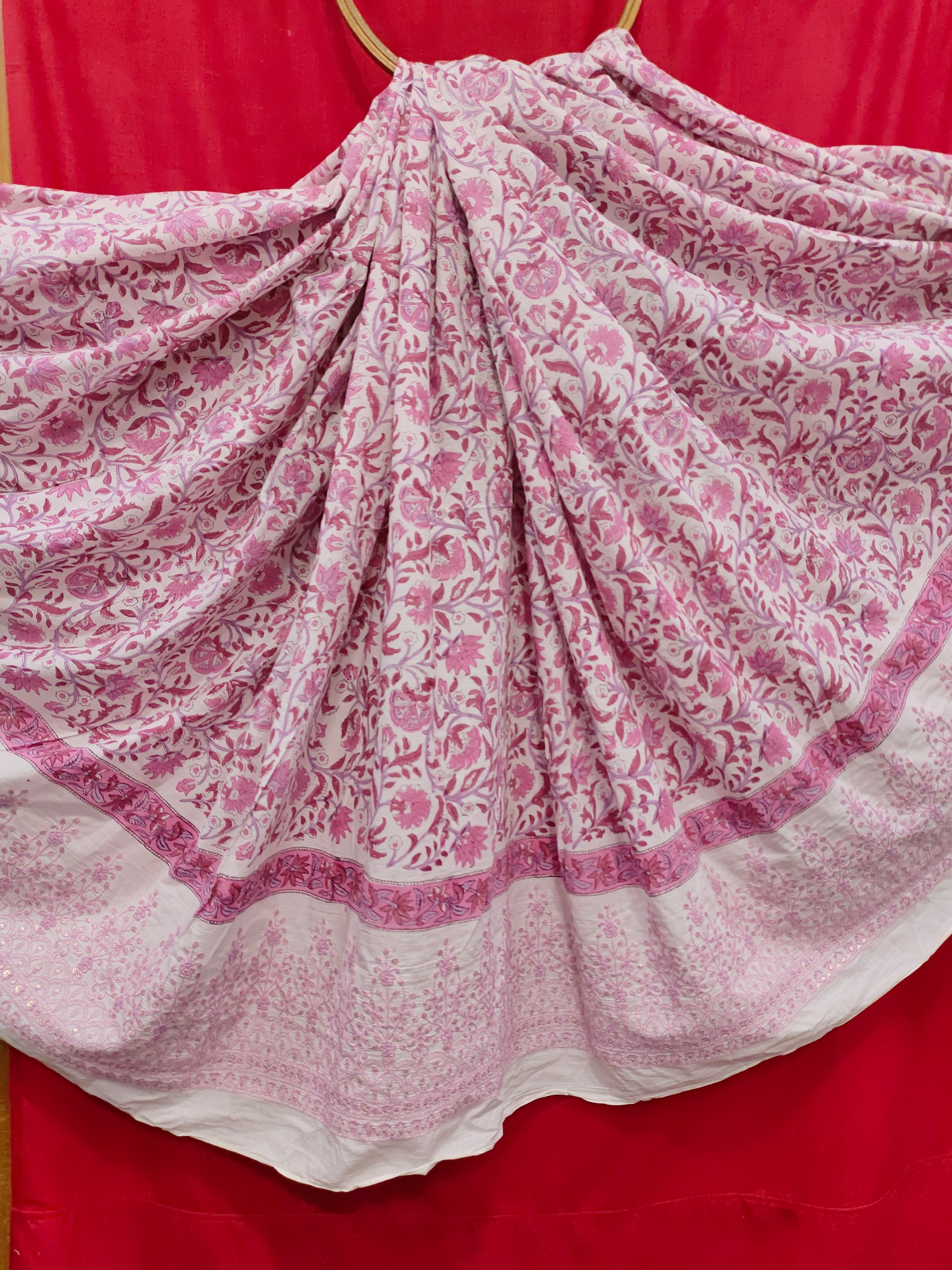 White fabric with pink handblock print and added with schiffli daman