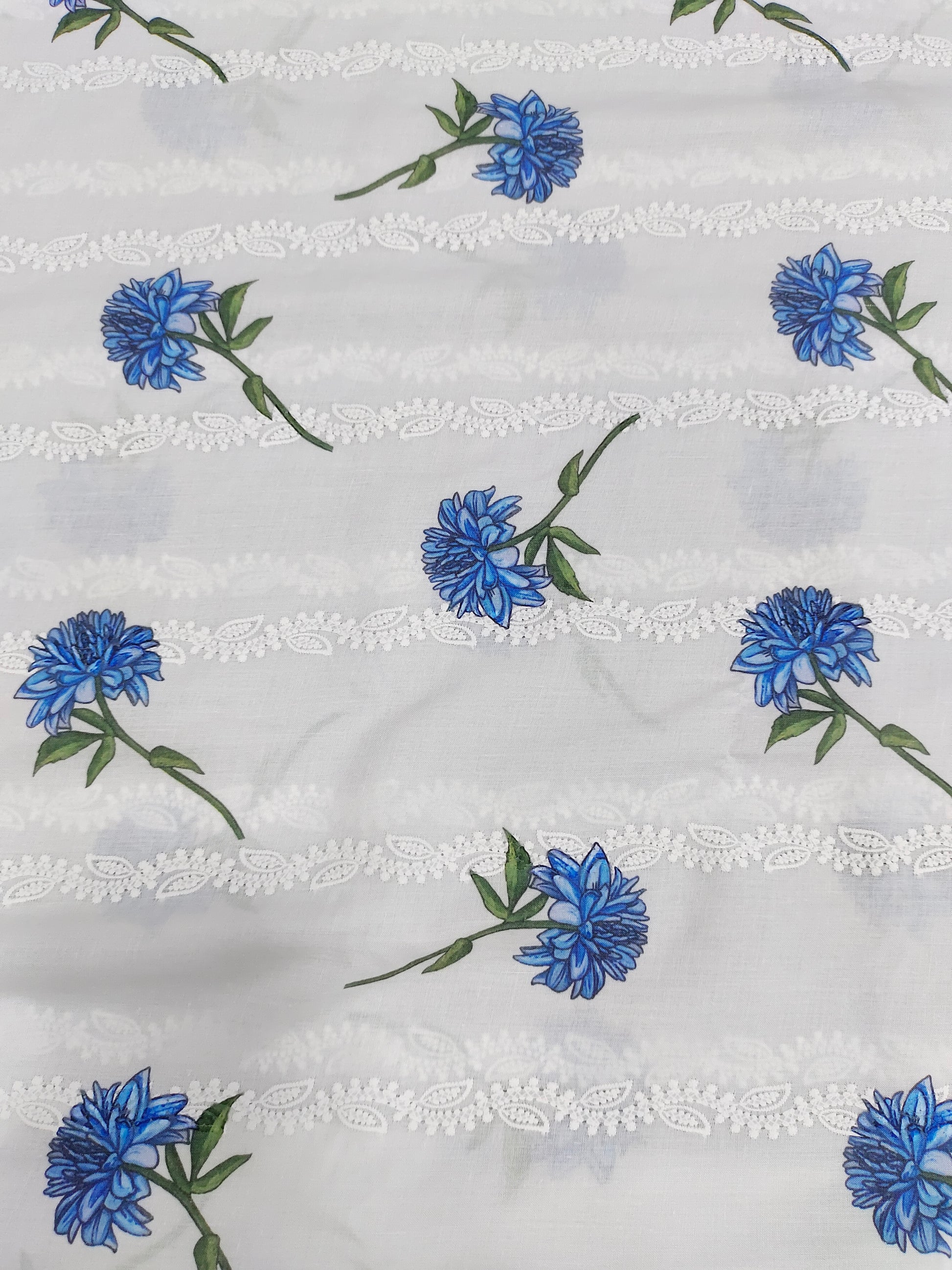 White embroidered with blue flowers