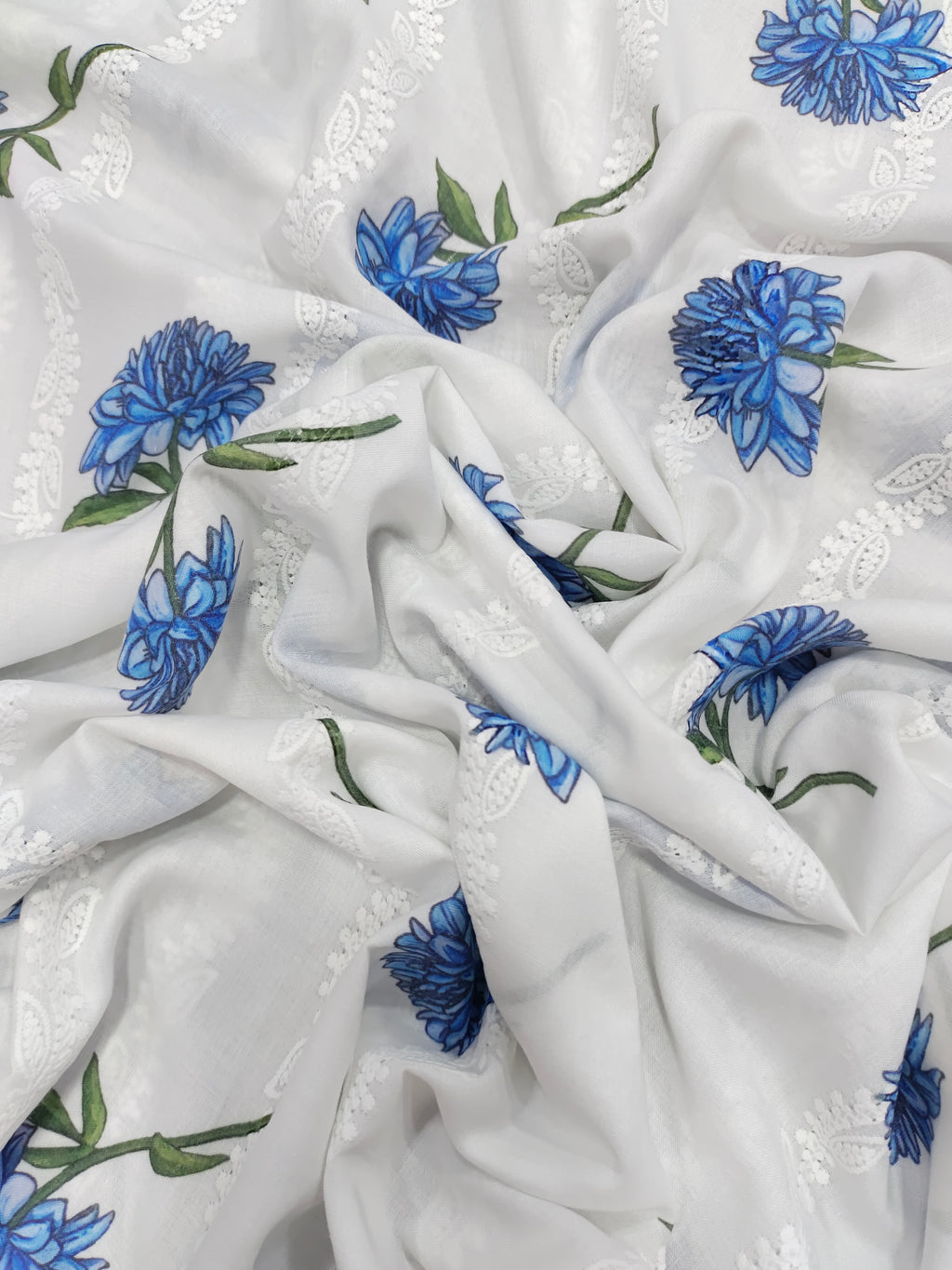 White embroidered with blue flowers